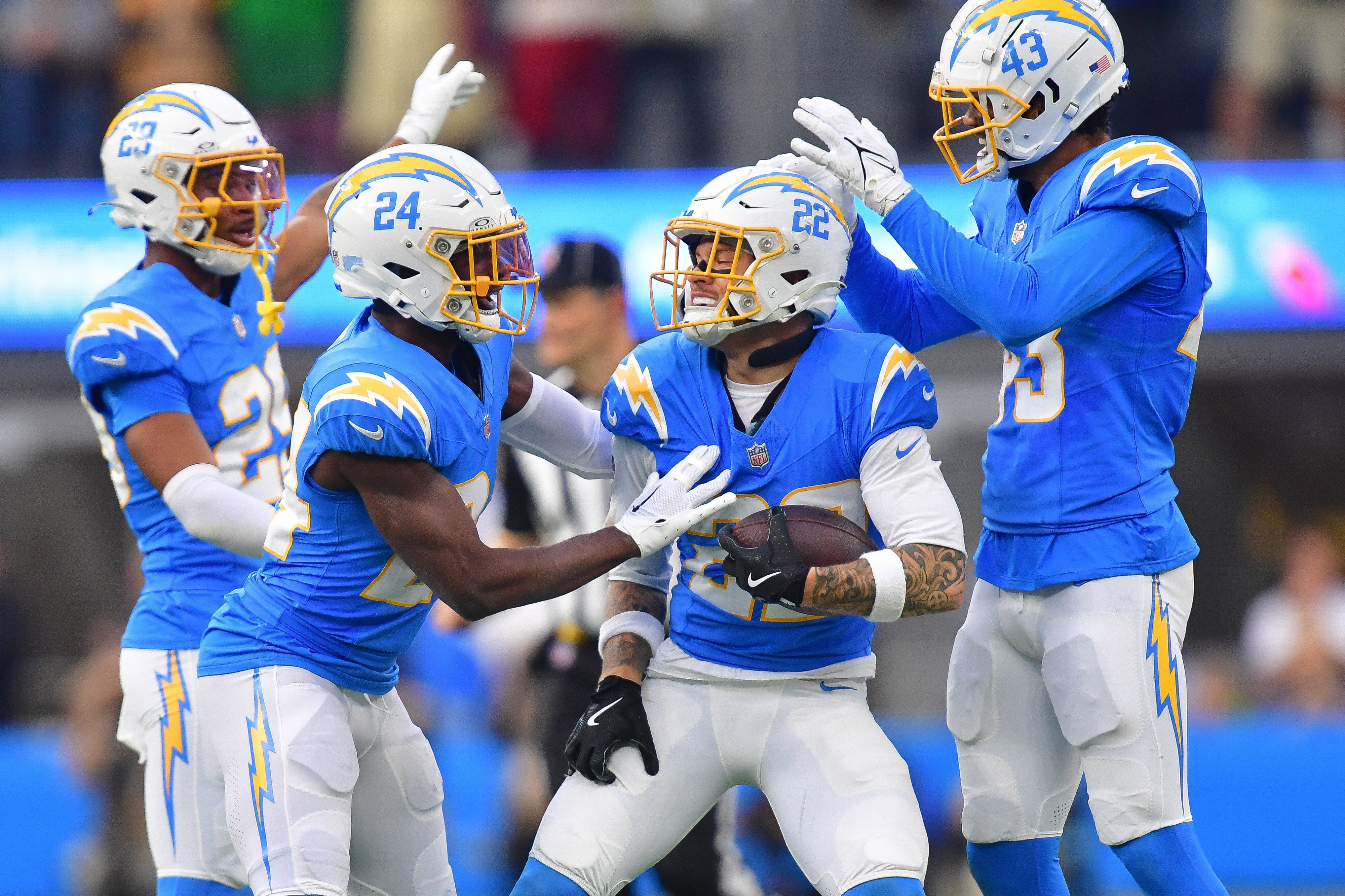 Chargers celebrate after cornerback Elijah Molden (22) recovers the fumble against the Buccaneers.