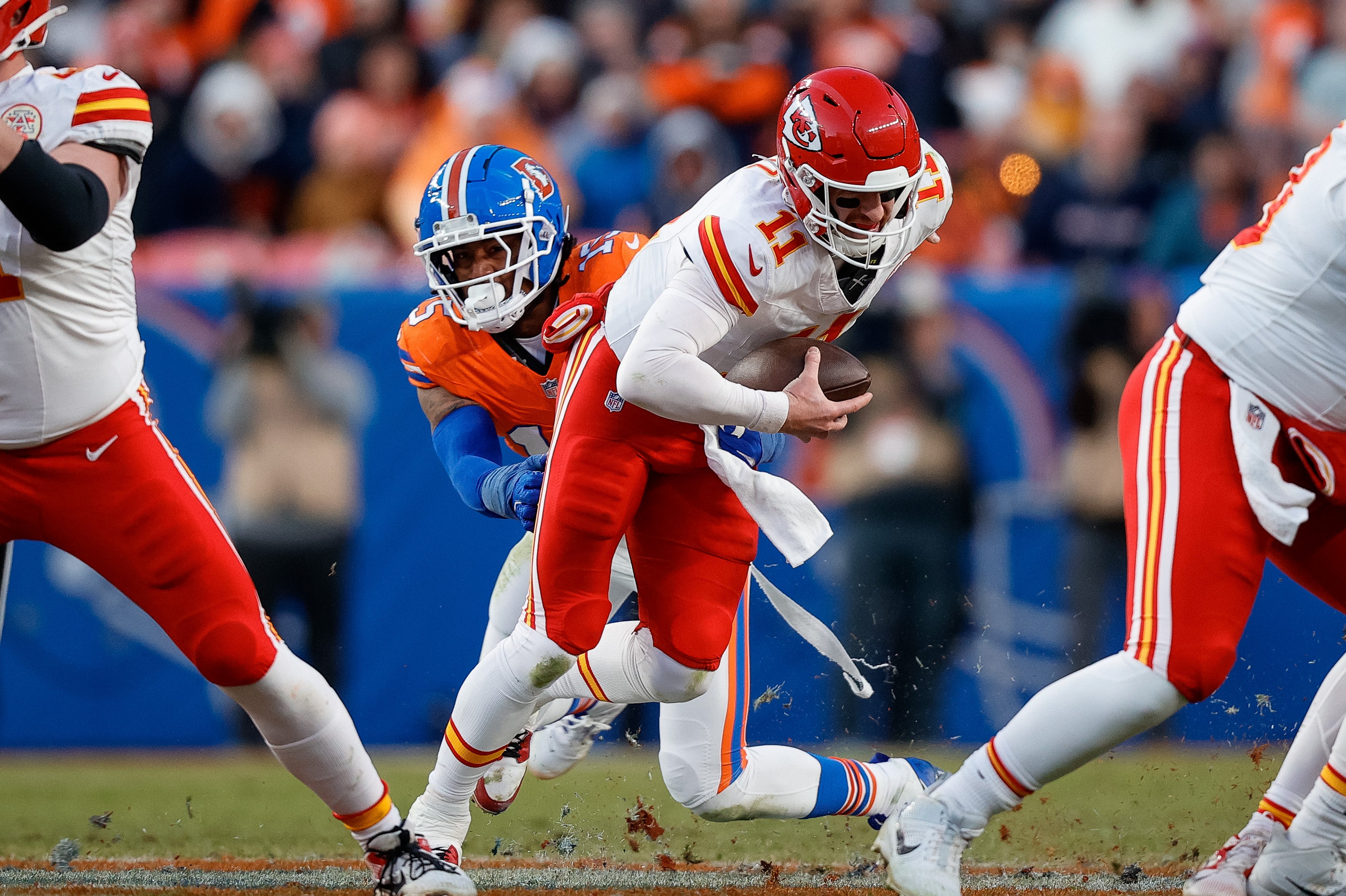 Chiefs quarterback Carson Wentz (11) is sacked by Broncos linebacker Nik Bonitto (15)