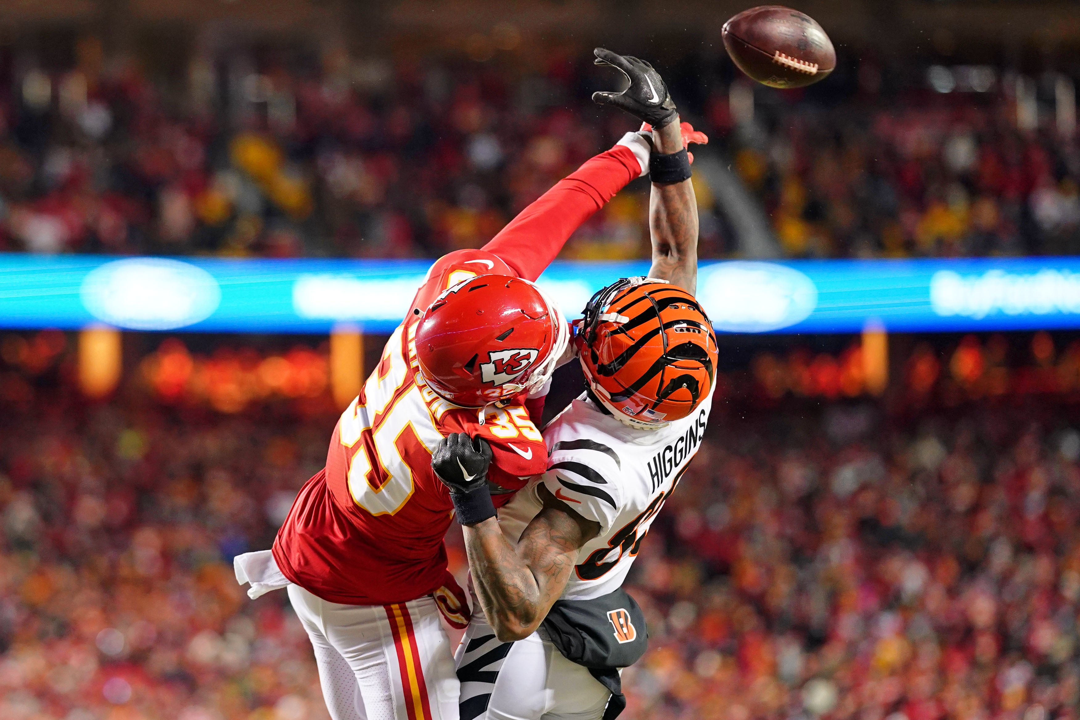 Jan 29, 2023; Kansas City, Missouri, USA; Kansas City Chiefs cornerback Jaylen Watson (35) battles for a pass against Cincinnati Bengals wide receiver Tee Higgins (85) during the second quarter of the AFC Championship game at GEHA Field at Arrowhead Stadium.