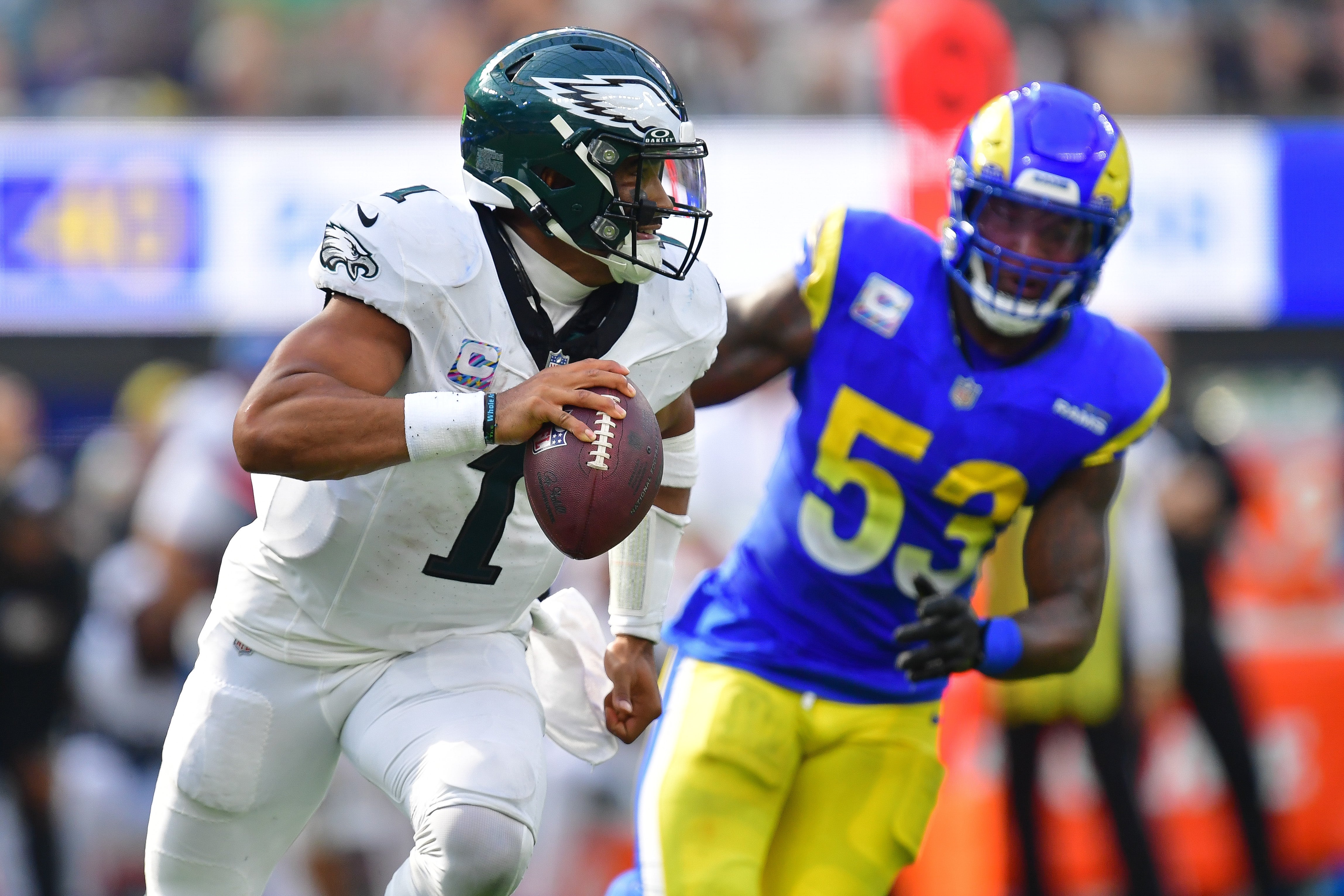 Philadelphia Eagles quarterback Jalen Hurts (1) runs the ball ahead of Los Angeles Rams linebacker Ernest Jones (53) during the second half at SoFi Stadium.