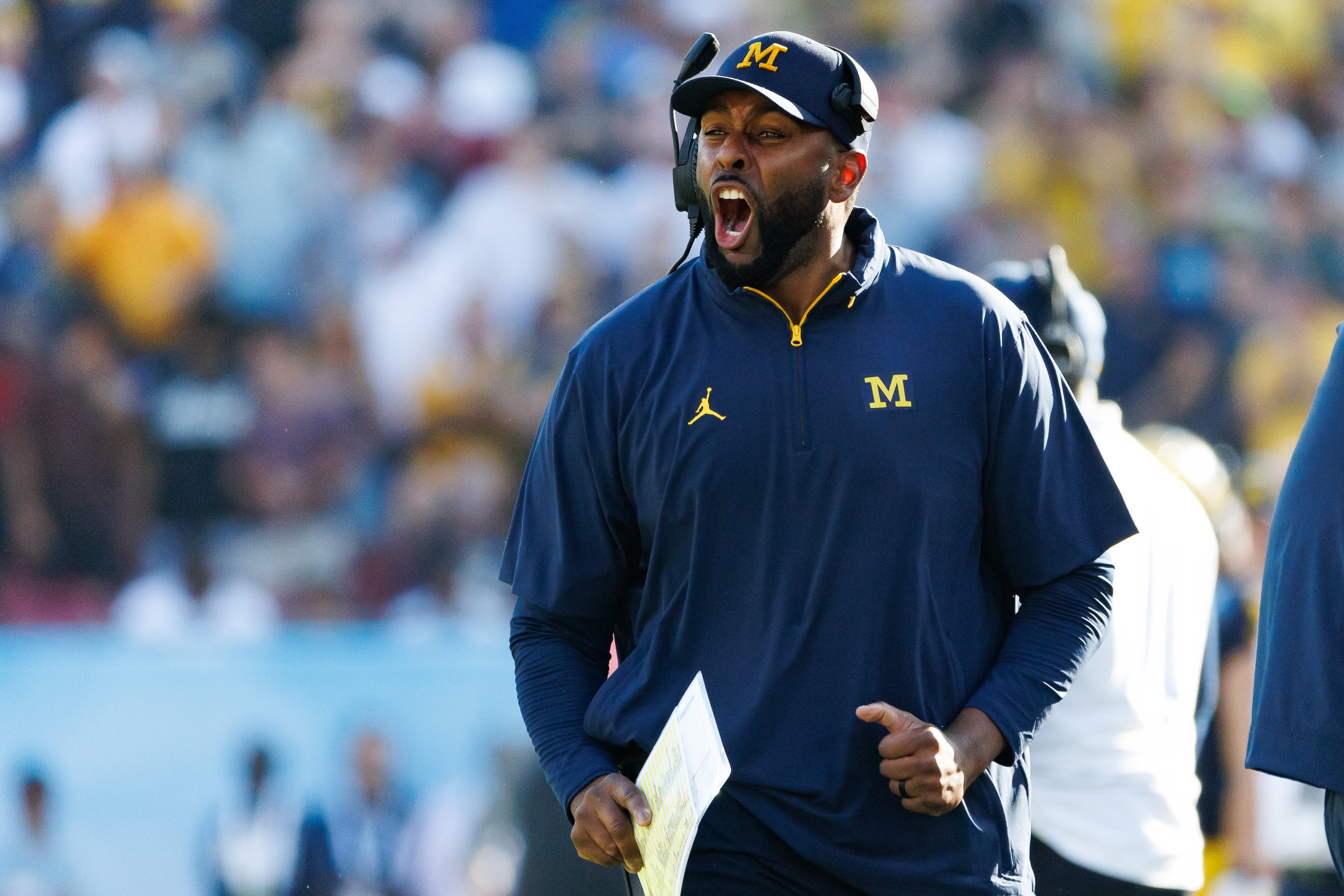 Dec 31, 2024; Tampa, FL, USA; Michigan Wolverines head coach Sherrone Moore screams from the sideline against the Alabama Crimson Tide during the second half at Raymond James Stadium.