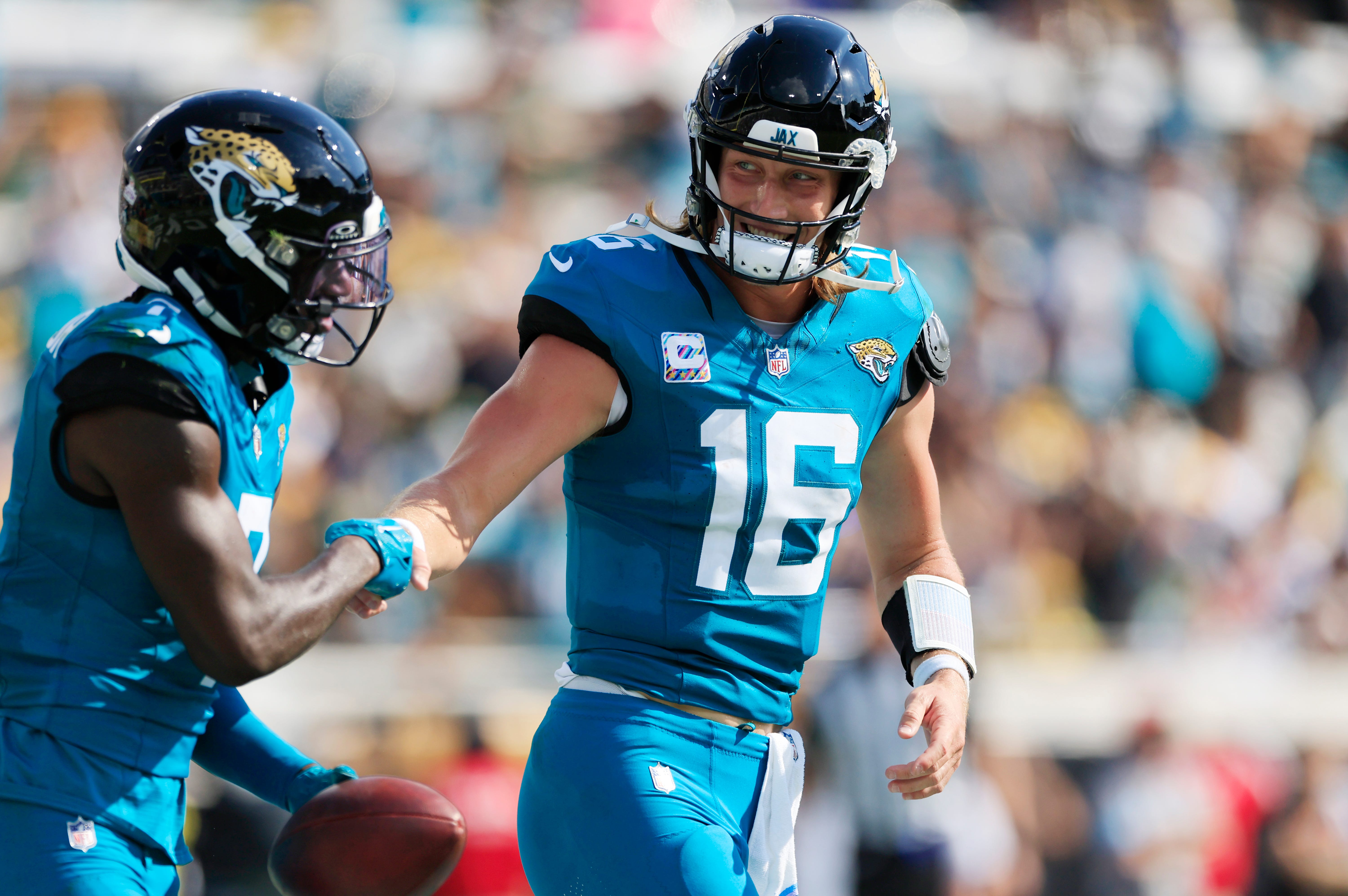 Jacksonville Jaguars quarterback Trevor Lawrence (16) congratulates wide receiver Brian Thomas Jr. (7) on his touchdown score during the third quarter of an NFL football matchup Sunday, Oct. 27, 2024 at EverBank Stadium in Jacksonville, Fla. The Packers edged the Jaguars 30-27 on a last-second field goal.