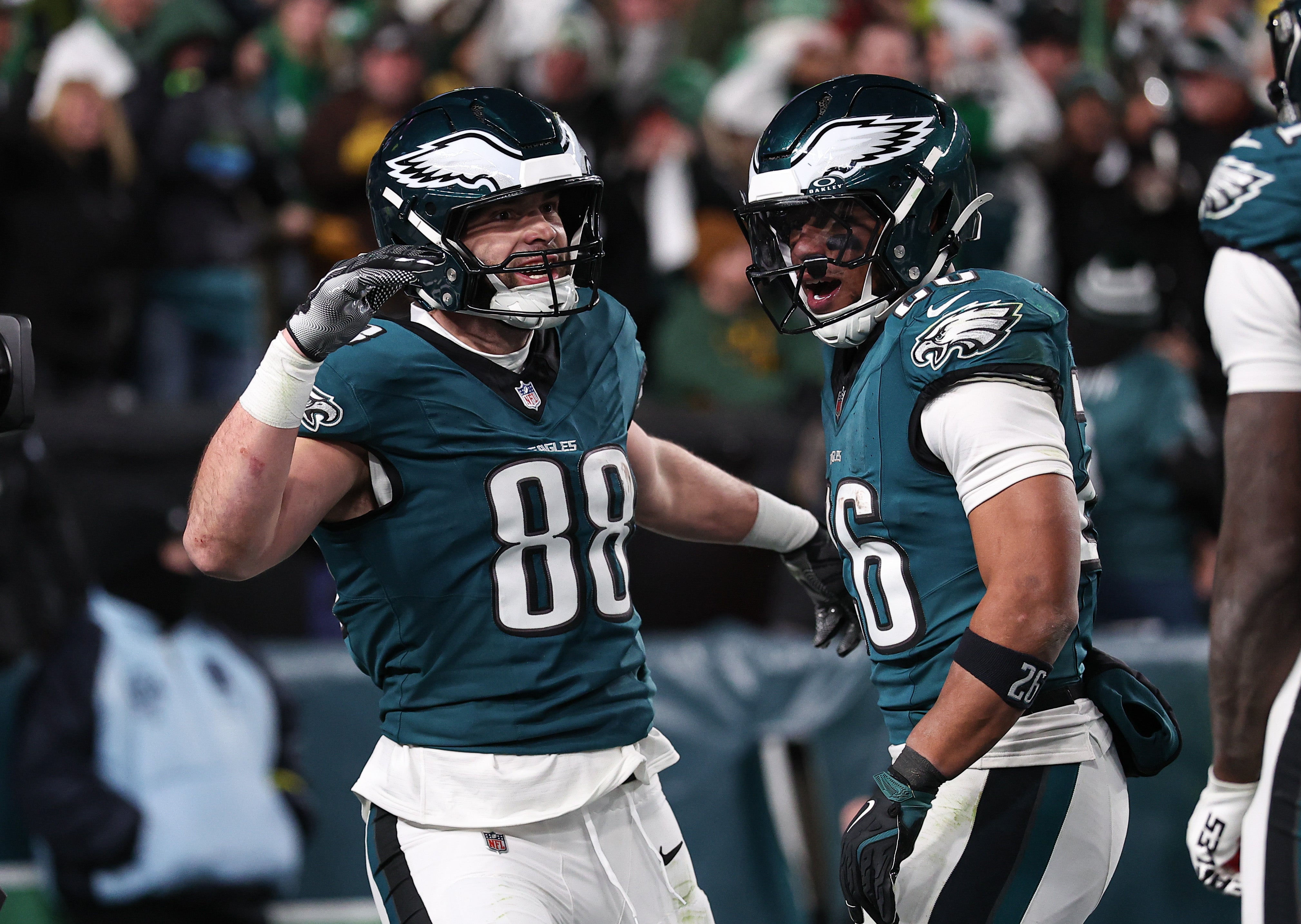 Philadelphia Eagles tight end Dallas Goedert (88) celebrates with running back Saquon Barkley (26) after his touchdown against the Green Bay Packers in an NFC wild card game at Lincoln Financial Field.