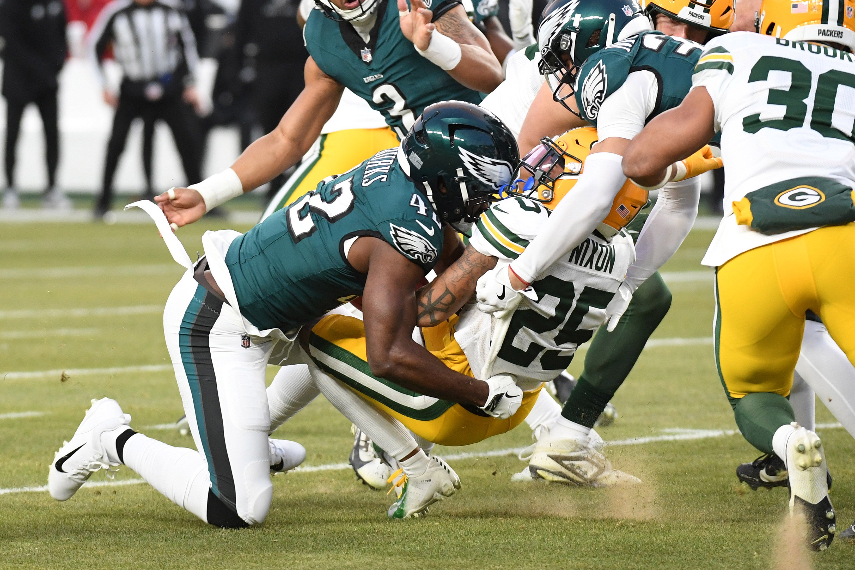 Philadelphia Eagles linebacker Oren Burks (42) causes a fumble on Green Bay Packers cornerback Keisean Nixon (25) for the opening kick off during the first half in an NFC wild card game at Lincoln Financial Field.