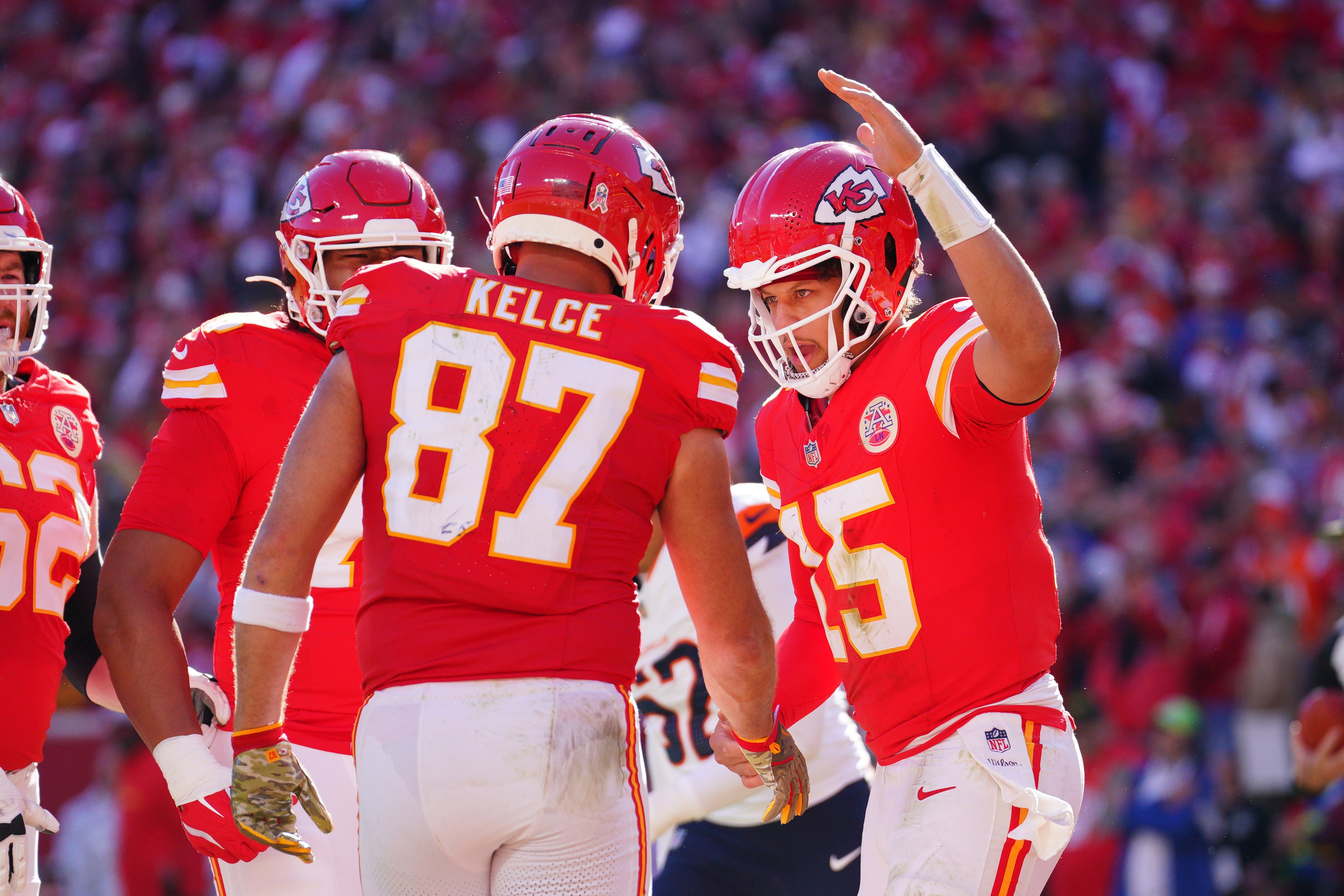 Chiefs tight end Travis Kelce (87) celebrates with quarterback Patrick Mahomes (15) after scoring against the Broncos.