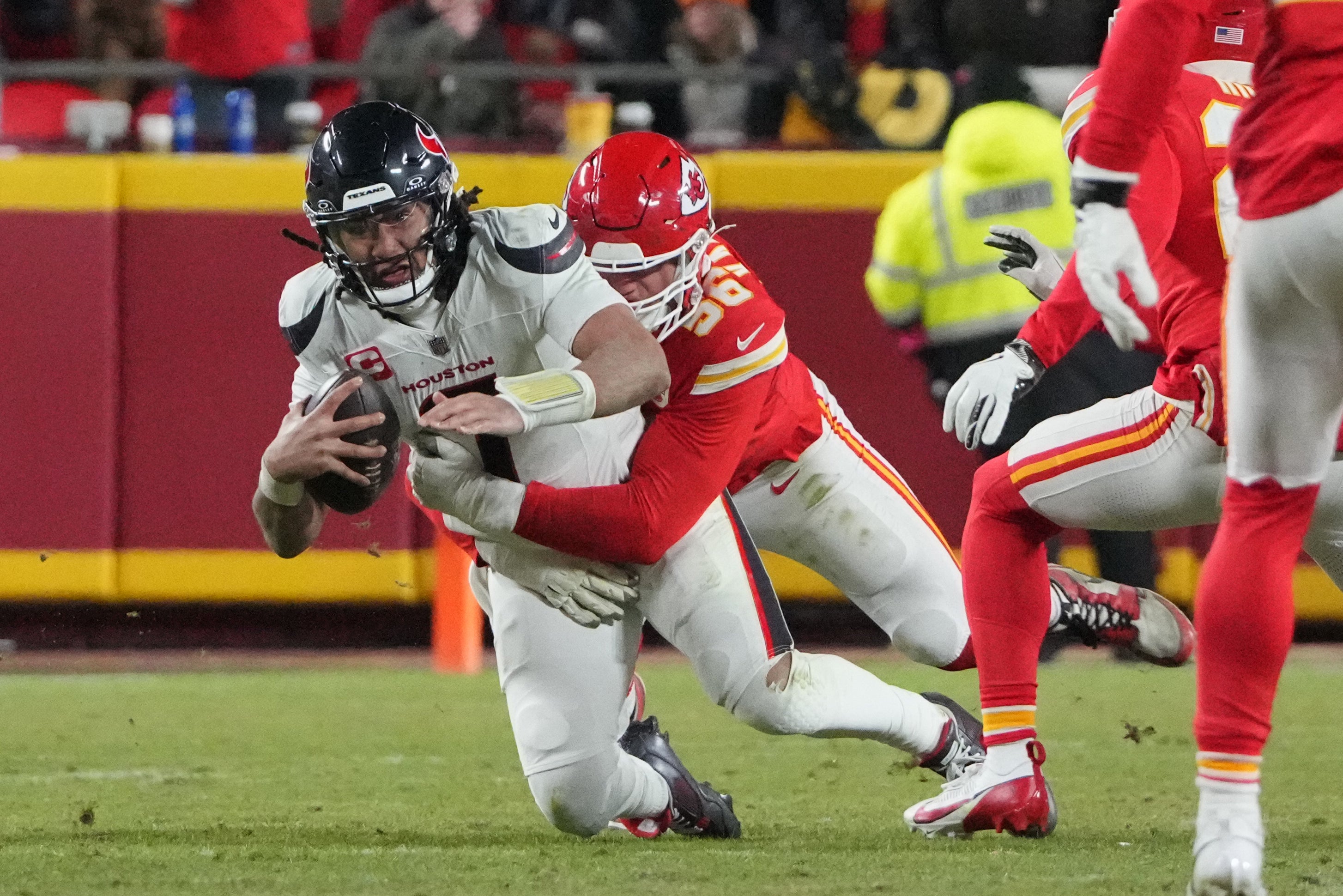 Houston Texans quarterback C.J. Stroud (7) is sacked by Kansas City Chiefs defensive end George Karlaftis (56) during the fourth quarter of a 2025 AFC divisional round game at GEHA Field at Arrowhead Stadium.