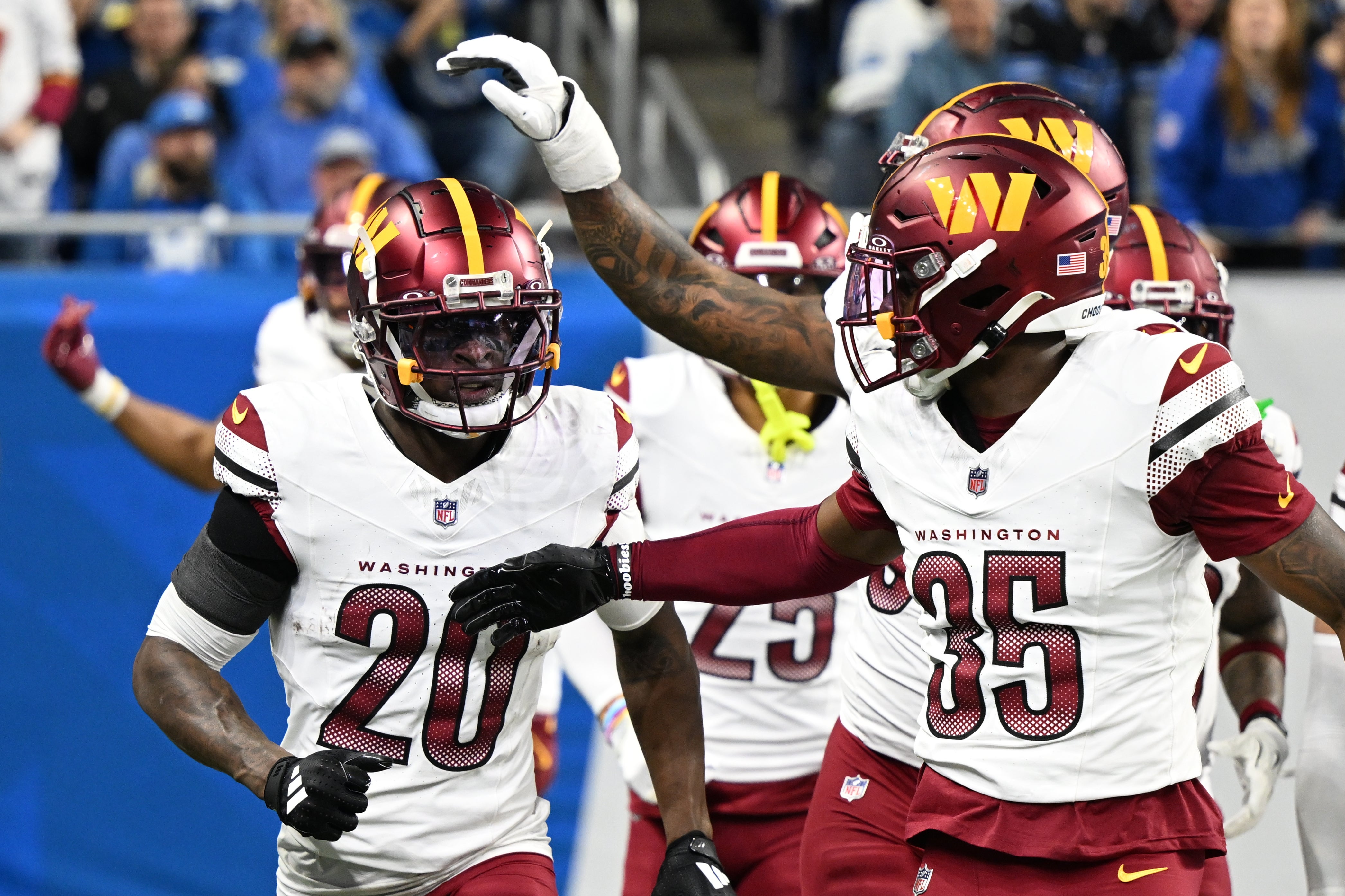 Jan 18, 2025; Detroit, Michigan, USA; Washington Commanders defensive back Quan Martin (20) celebrates a touchdown after an interception during the second quarter against Detroit Lions in a 2025 NFC divisional round game at Ford Field.