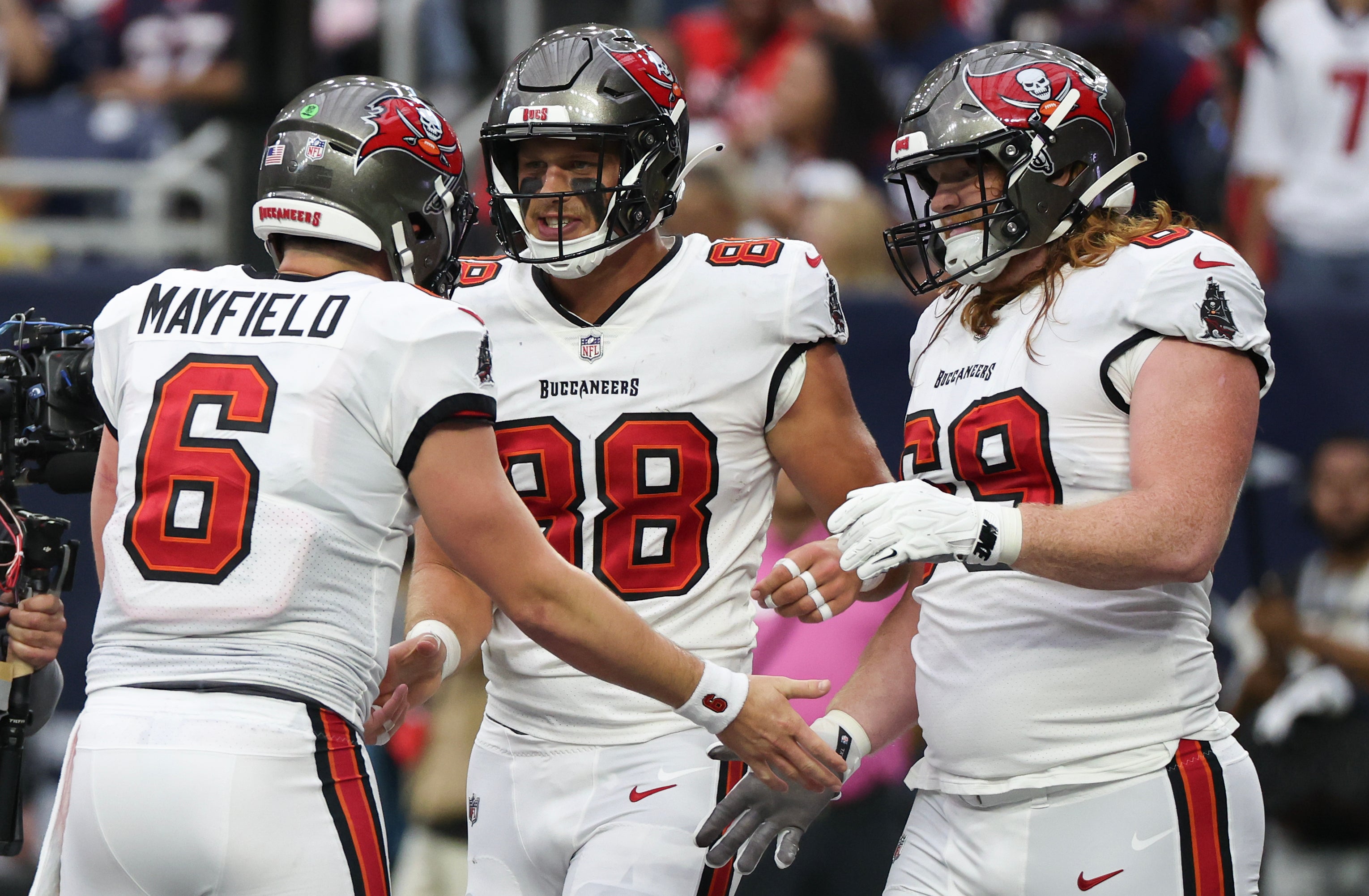 Nov 5, 2023; Houston, Texas, USA; Tampa Bay Buccaneers quarterback Baker Mayfield (6) and T guard Cody Mauch (69) celebrates Tampa Bay Buccaneers tight end Cade Otton (88) touchdown reception against the Houston Texans in the first quarter at NRG Stadium.