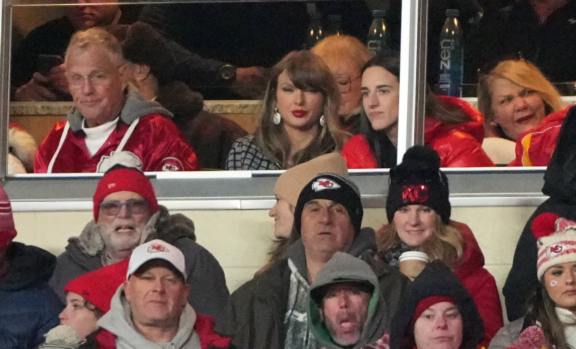 Jan 18, 2025; Kansas City, Missouri, USA; Recording artist Taylor Swift (upper middle) sits with Indiana Fever guard Caitlin Clark (upper right) during the fourth quarter of a 2025 AFC divisional round game between the Kansas City Chiefs and the Houston Texans at GEHA Field at Arrowhead Stadium.