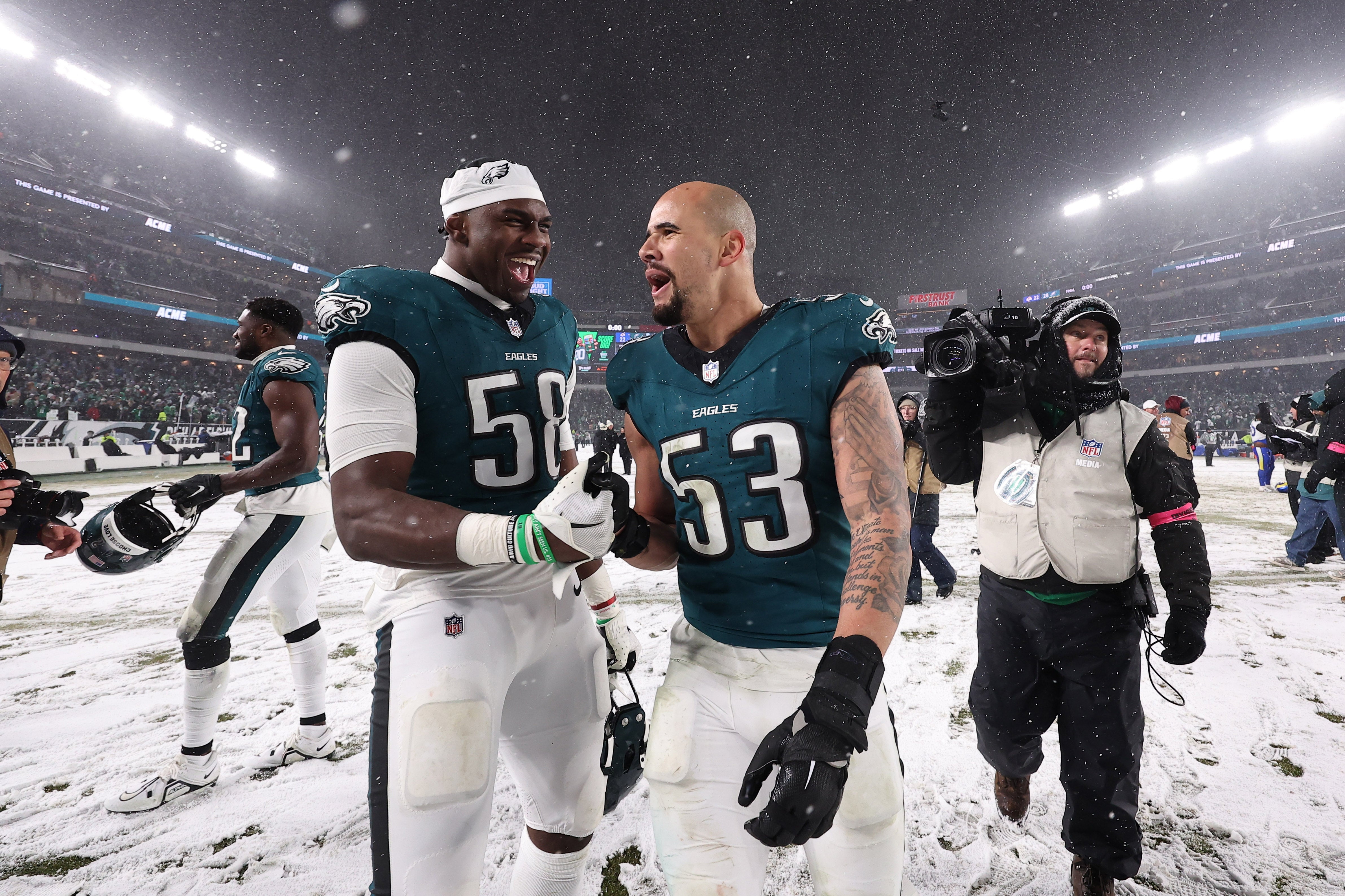 Philadelphia Eagles linebacker Jalyx Hunt (58) celebrates with Philadelphia Eagles linebacker Zack Baun (53) after defeating the Los Angeles Rams in a 2025 NFC divisional round game at Lincoln Financial Field.