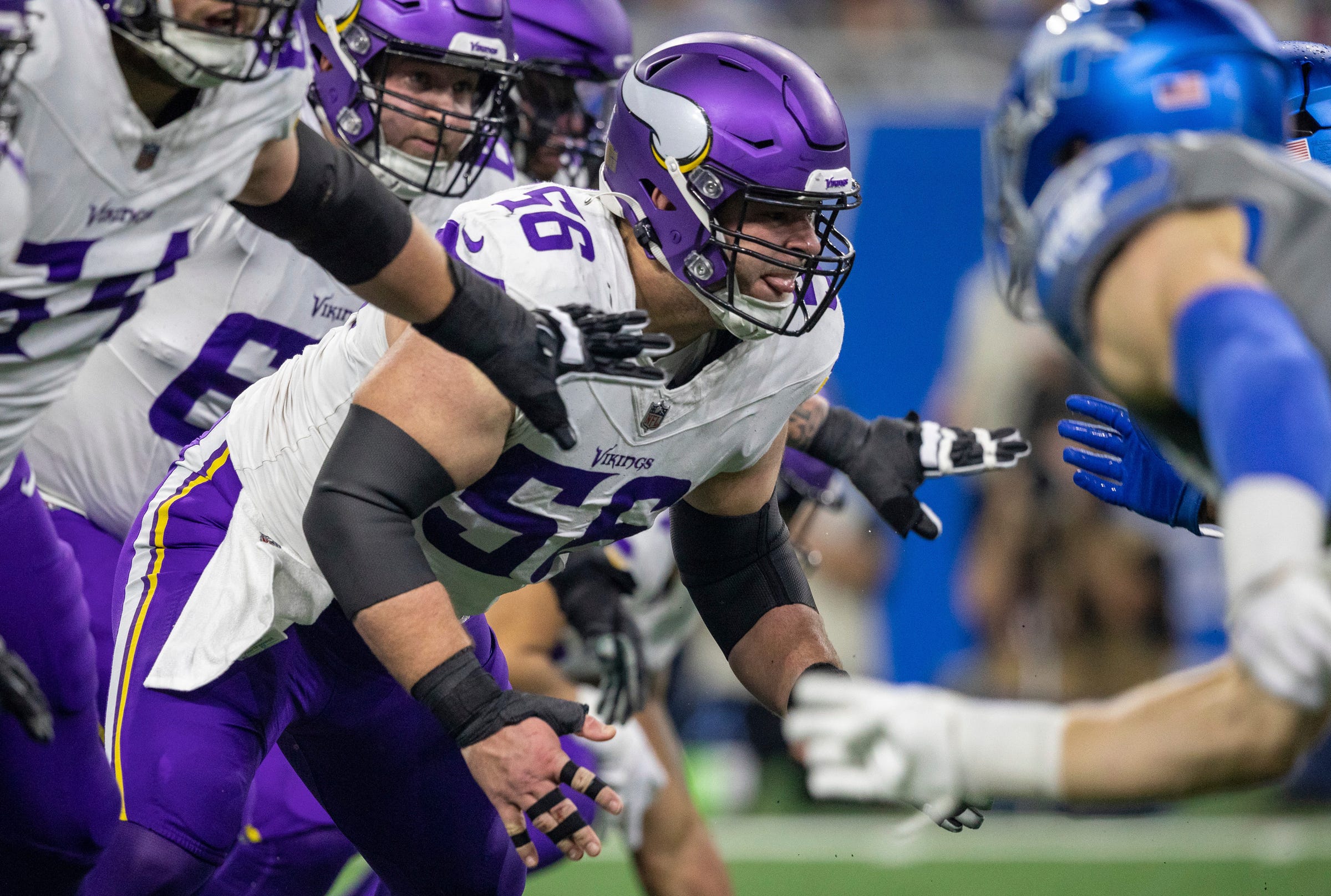 Minnesota Vikings center Garrett Bradbury (56) protects his quarterback during a play against the Detroit Lions defense at Ford Field in Detroit on Sunday, Jan. 7, 2024.