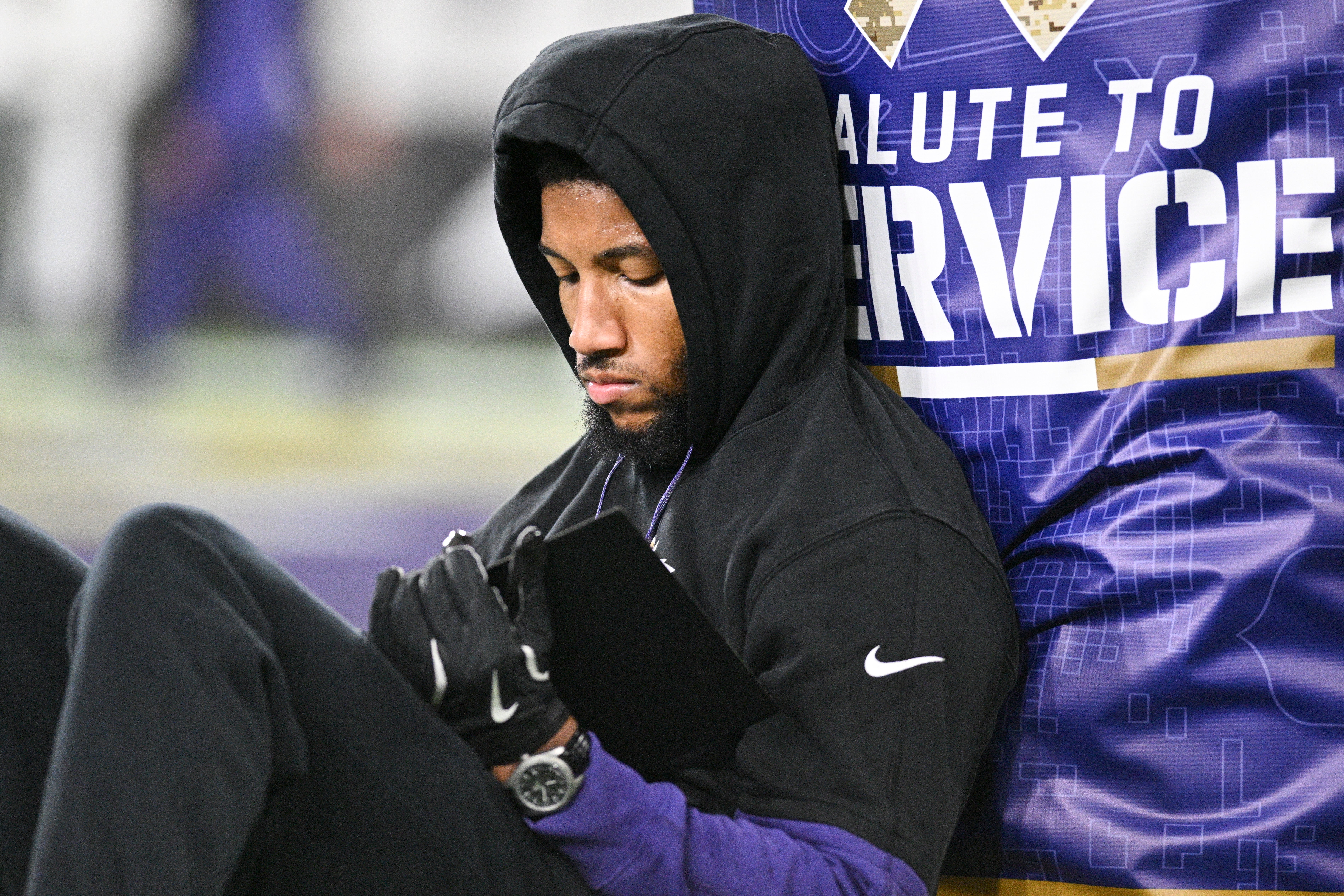 Nov 7, 2024; Baltimore, Maryland, USA; Baltimore Ravens cornerback Marlon Humphrey (44) sits next to a goal post while looking at a tablet before the game against the Cincinnati Bengals at M&T Bank Stadium.