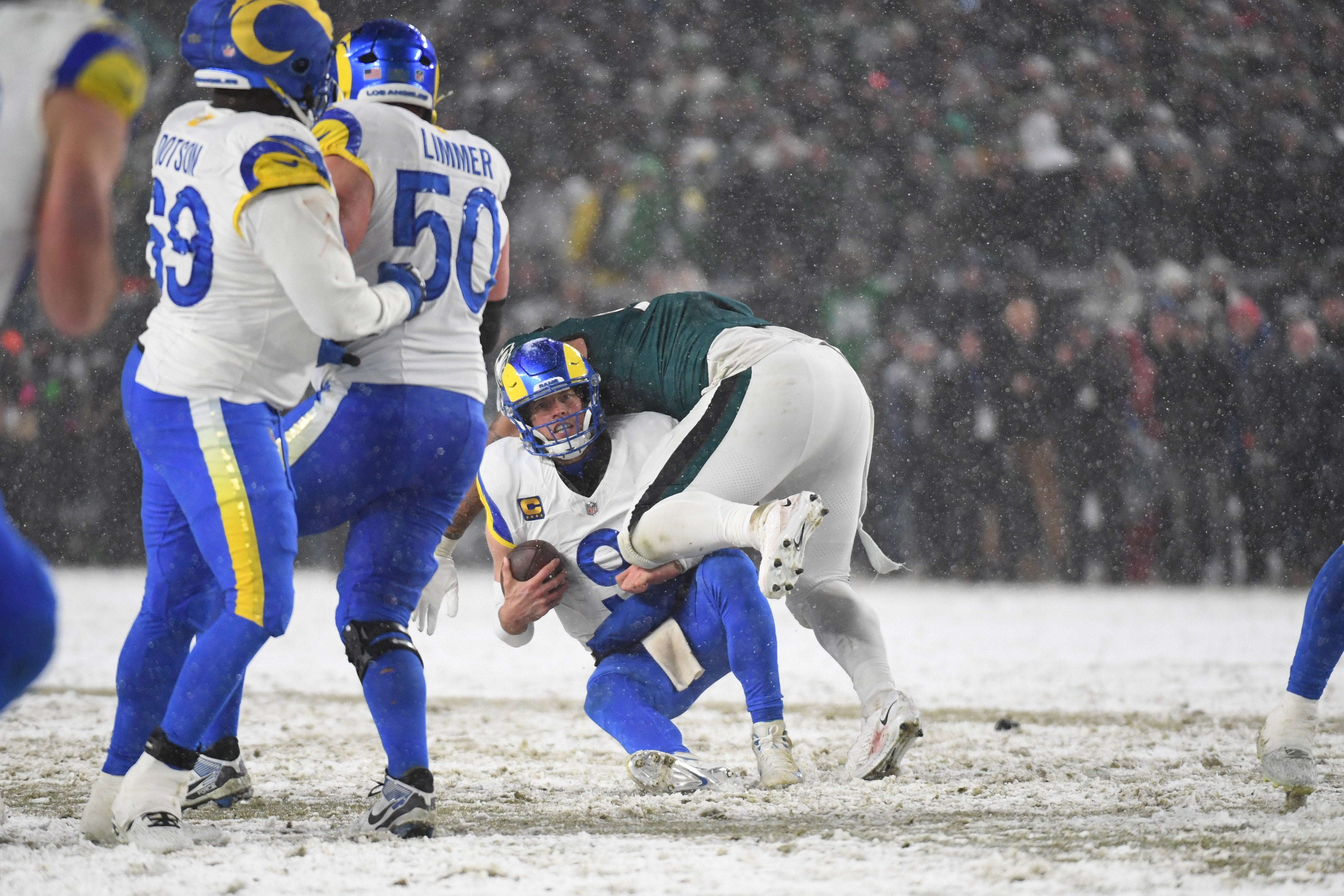 Los Angeles Rams quarterback Matthew Stafford (9) is sacked by Philadelphia Eagles defensive tackle Jalen Carter (98) during the fourth quarter in a 2025 NFC divisional round game at Lincoln Financial Field.