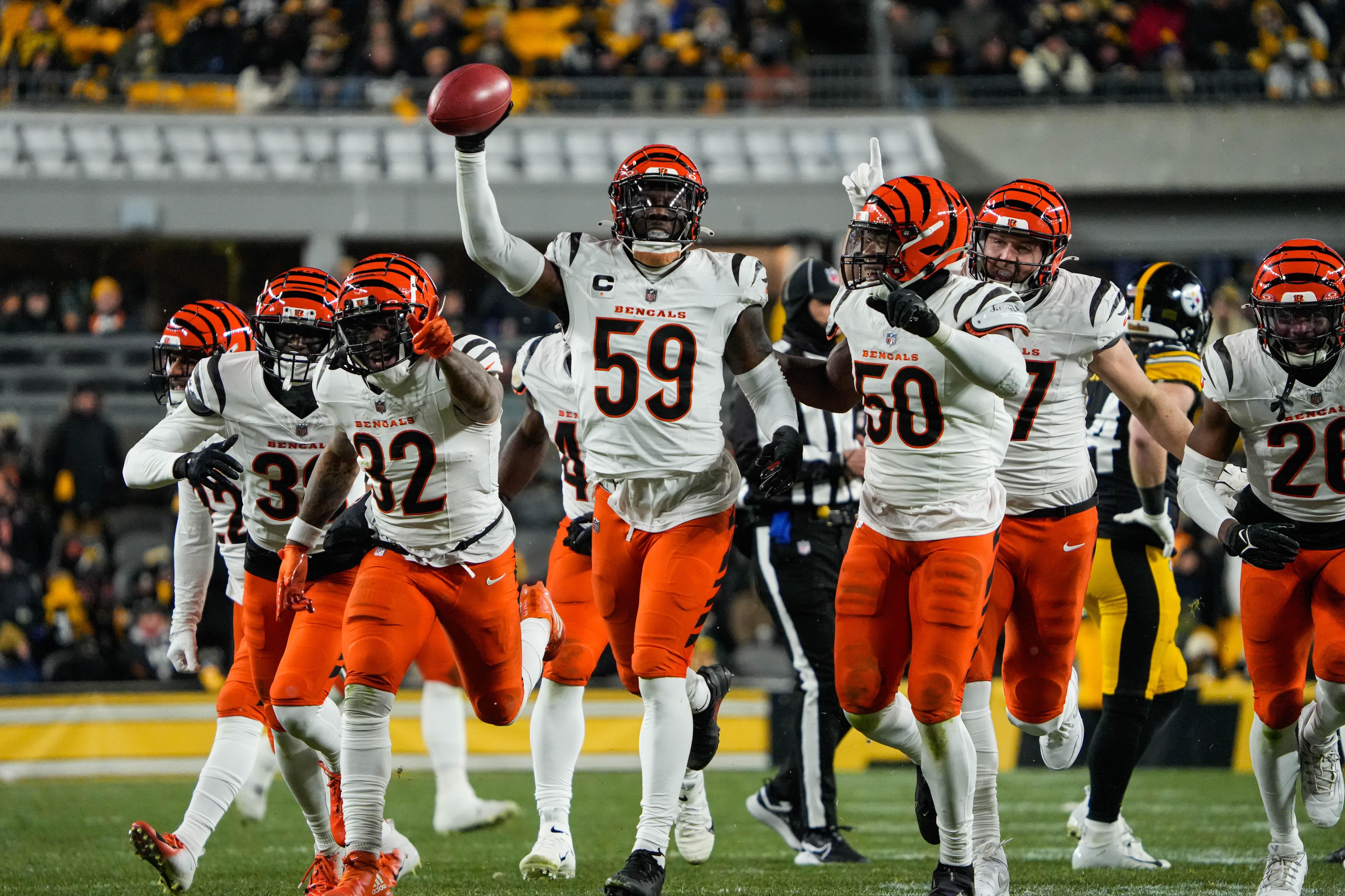 Bengals Akeem Davis-Gaither (59) recovers a fumble and celebrates with the team during their game against the Steelers at Acrisure Stadium on Saturday January 4, 2025. The Bengals lead the game at halftime with a score of 13-7.