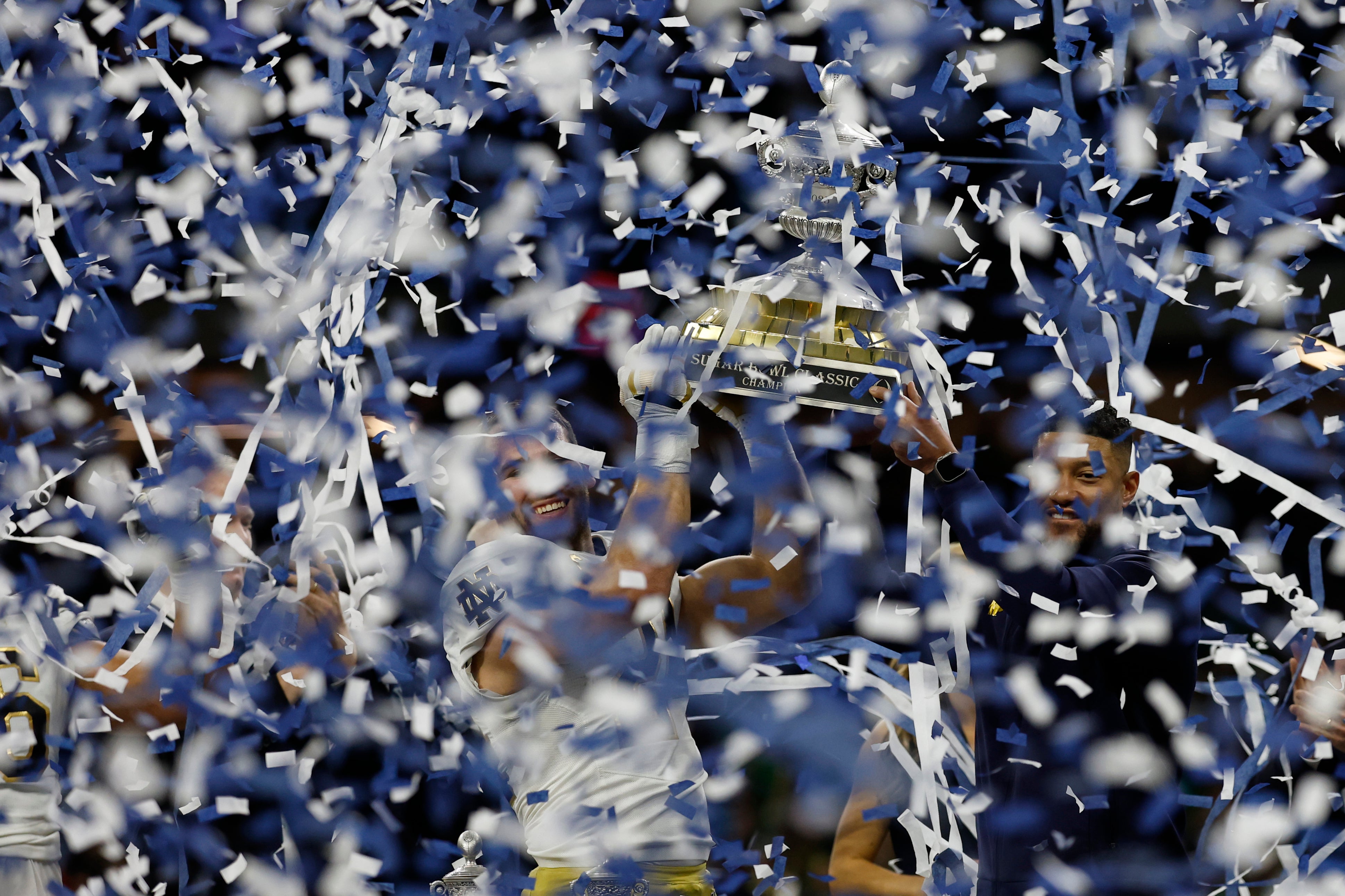 Notre Dame Fighting Irish head coach Marcus Freeman (R) and Fighting Irish linebacker Jack Kiser (24) celebrate with the Sugar Bowl trophy after their game against the Georgia Bulldogs at Caesars Superdome.