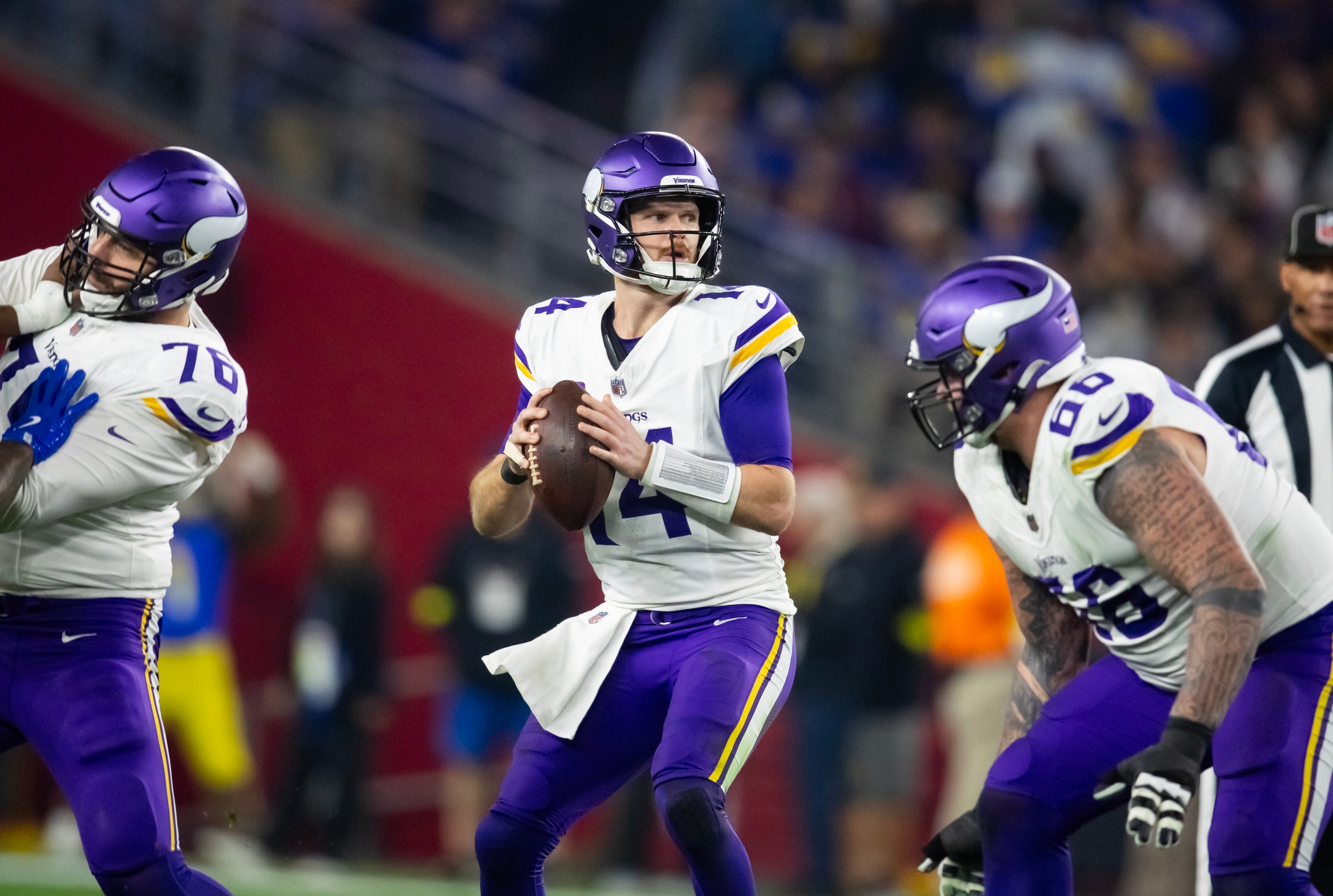 Jan 13, 2025; Glendale, AZ, USA; Minnesota Vikings quarterback Sam Darnold (14) against the Los Angeles Rams during an NFC wild card game at State Farm Stadium.