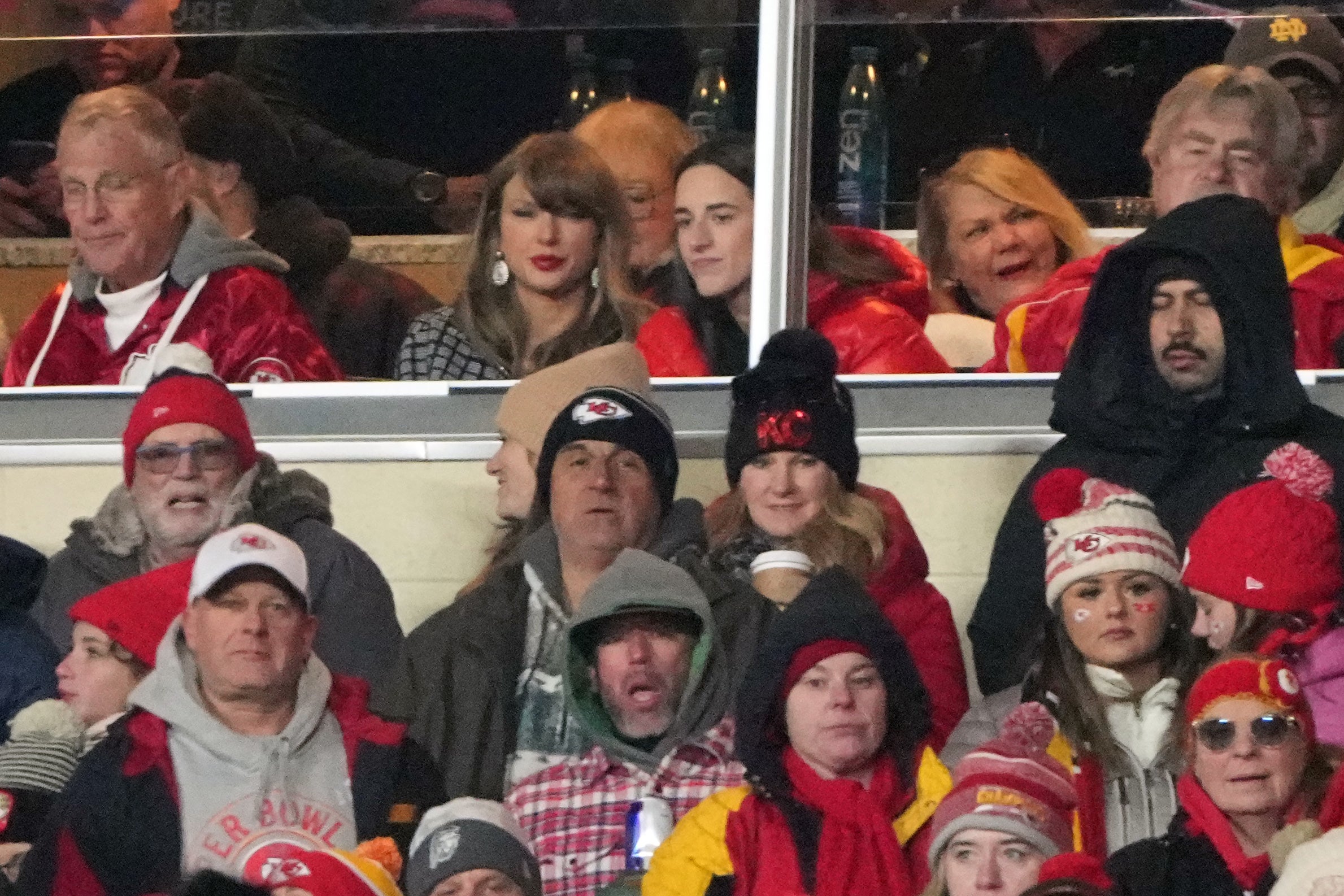 Jan 18, 2025; Kansas City, Missouri, USA; Recording artist Taylor Swift (upper middle) sits with Indiana Fever guard Caitlin Clark (upper right) during the fourth quarter of a 2025 AFC divisional round game between the Kansas City Chiefs and the Houston Texans at GEHA Field at Arrowhead Stadium.