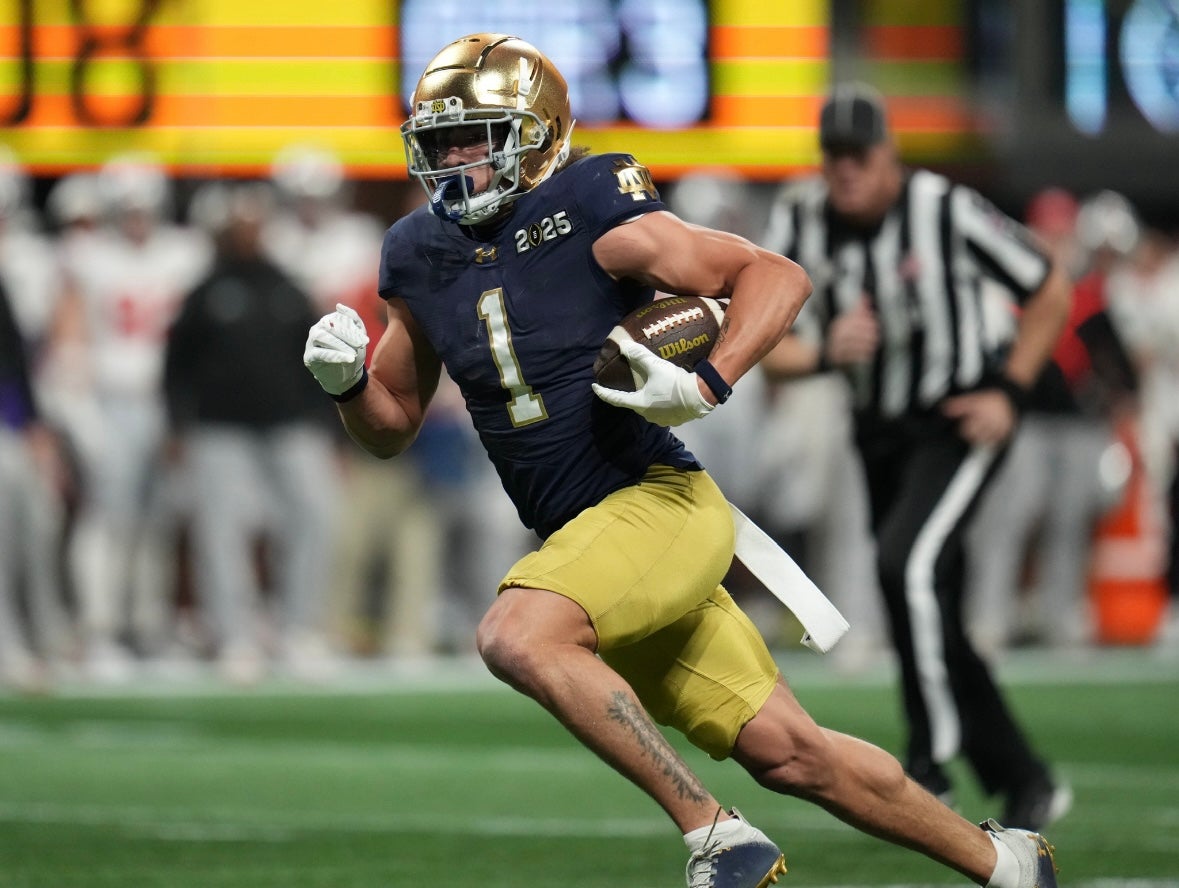 Notre Dame Fighting Irish wide receiver Jaden Greathouse (1) runs the ball against the Ohio State Buckeyes in the second half in the CFP National Championship college football game at Mercedes-Benz Stadium.