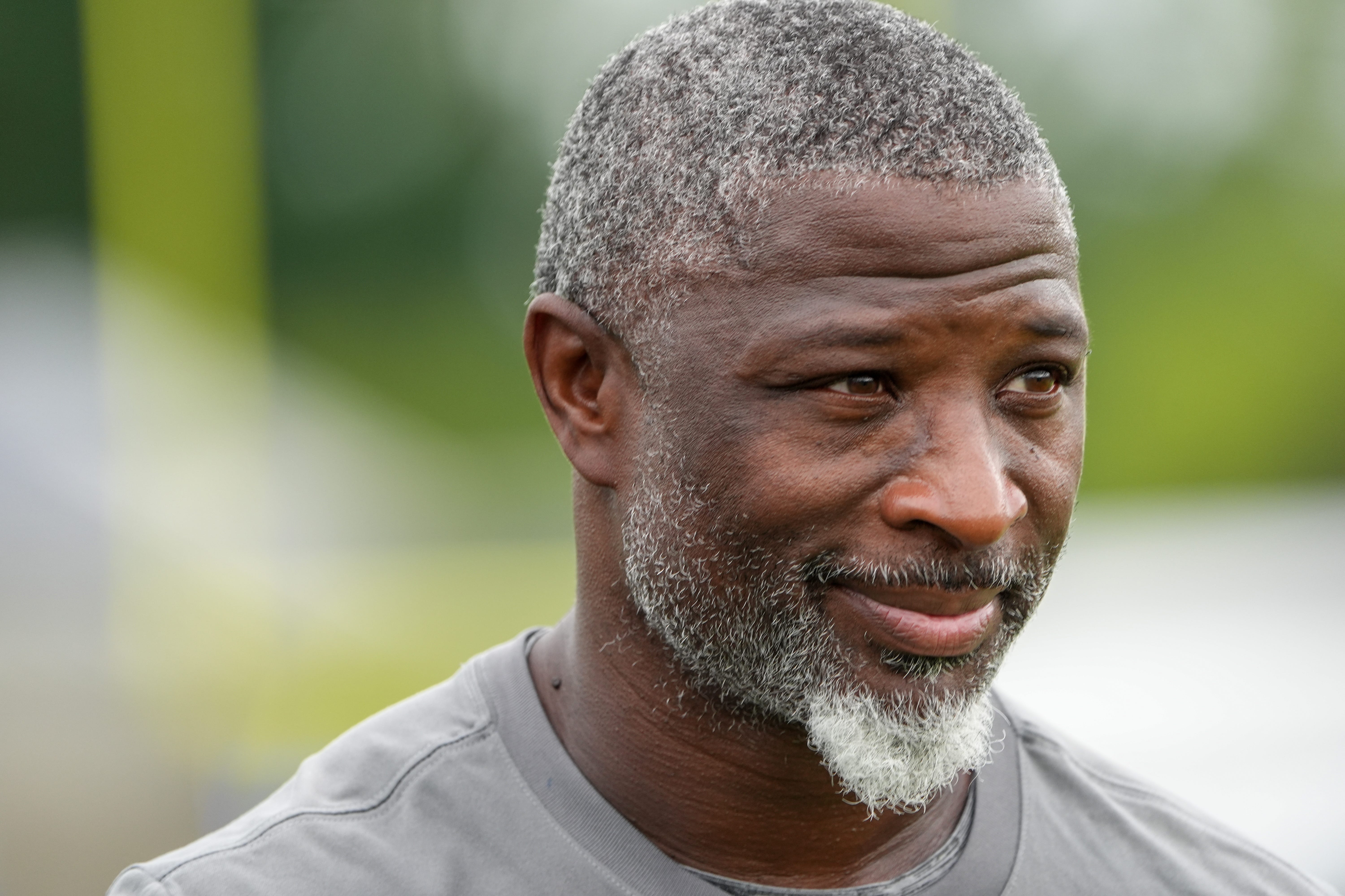 Defensive Coordinator Aaron Glenn walks off the field after the Detroit Lions training camp at the Lions practice facility in Allen Park, Mich. on Monday, July 29, 2024.