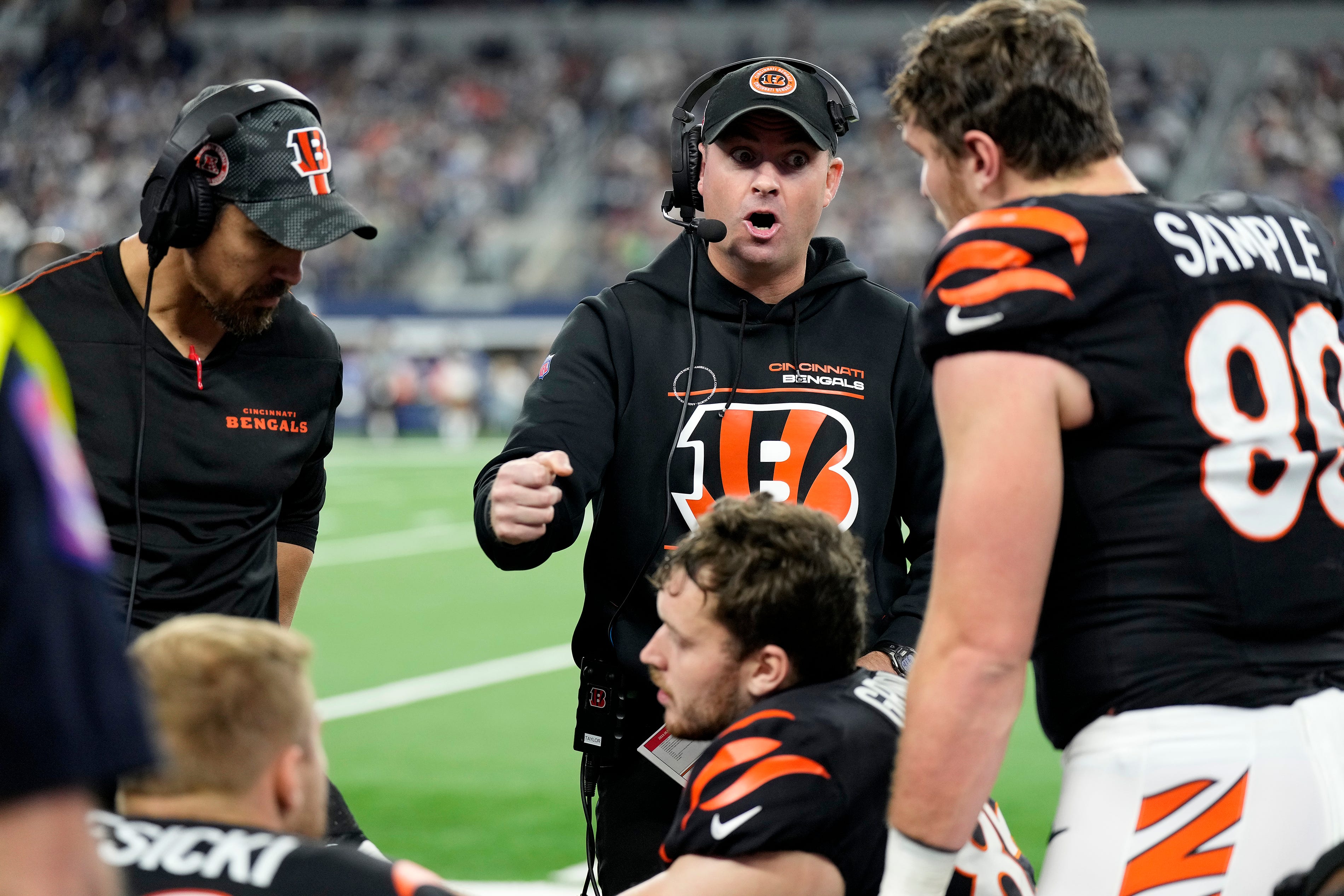 Cincinnati Bengals head coach Zac Taylor talks with tight end Drew Sample (89) and other players as they take on Dallas Cowboys Monday Night Football at AT&T Stadium in Arlington,Texas on Monday, December 9, 2024.