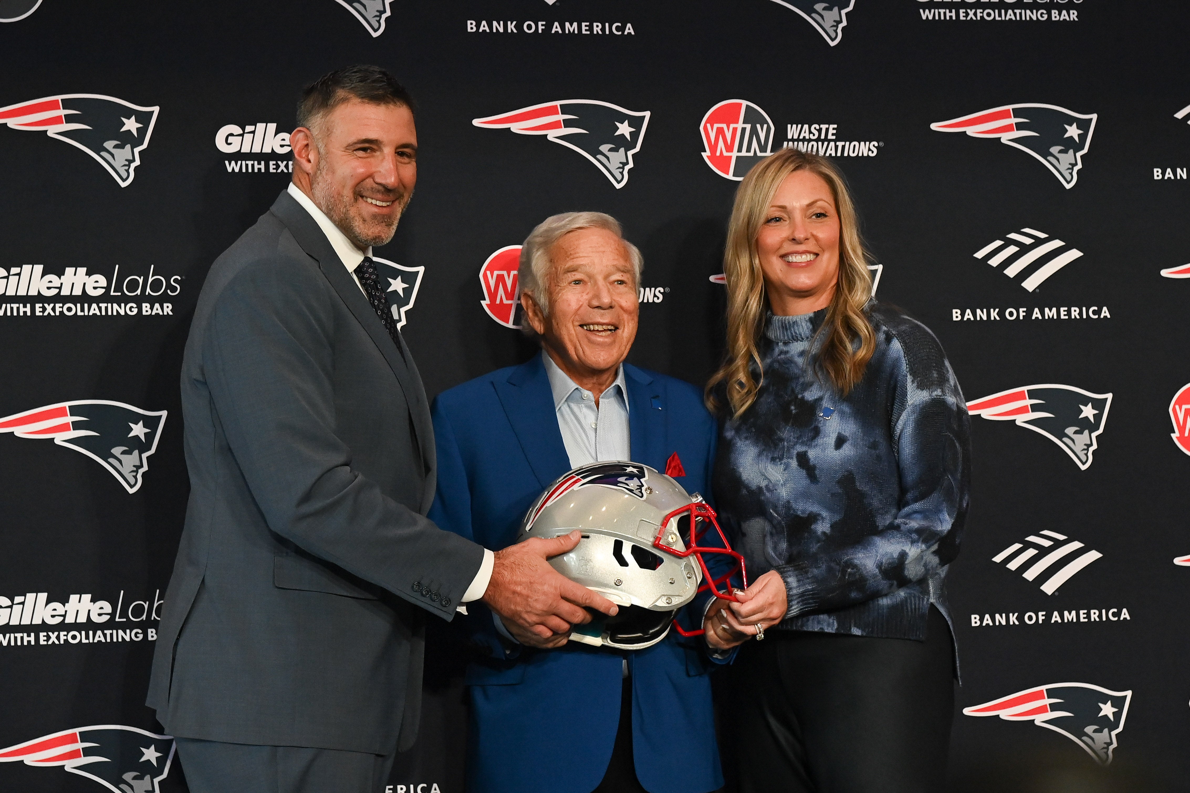 Jan 13, 2025; Foxborough, MA, USA; Mike Vrabel (l) and his wife Jennifer (r) pose for a photo with New England Patriots owner Robert Kraft (c) after a press conference at Gillette Stadium to introduce Vrabel as the Patriots head coach.