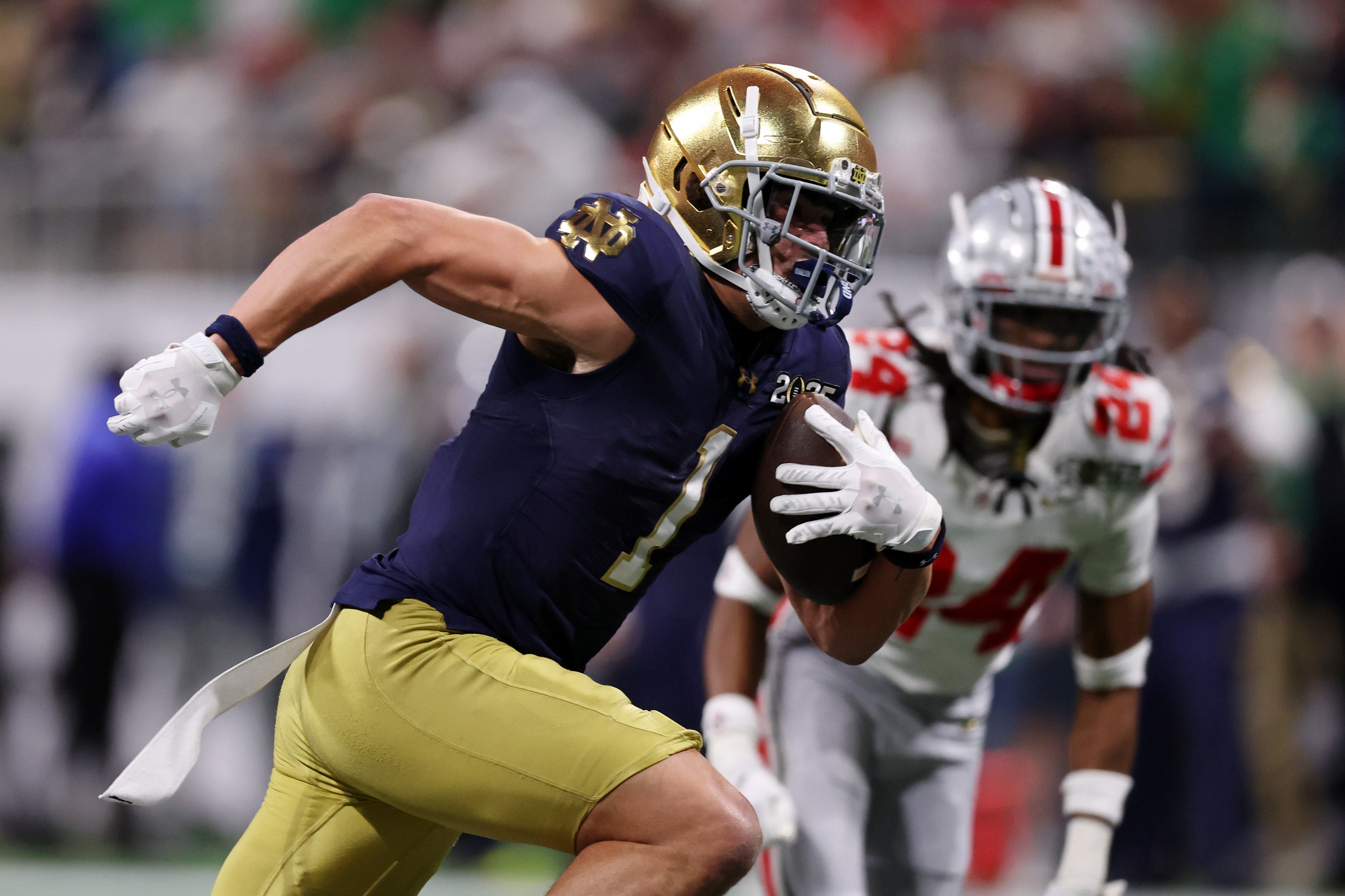 Notre Dame Fighting Irish wide receiver Jaden Greathouse (1) runs with the ball for a touchdown against the Ohio State Buckeyes during the second half the CFP National Championship college football game at Mercedes-Benz Stadium.