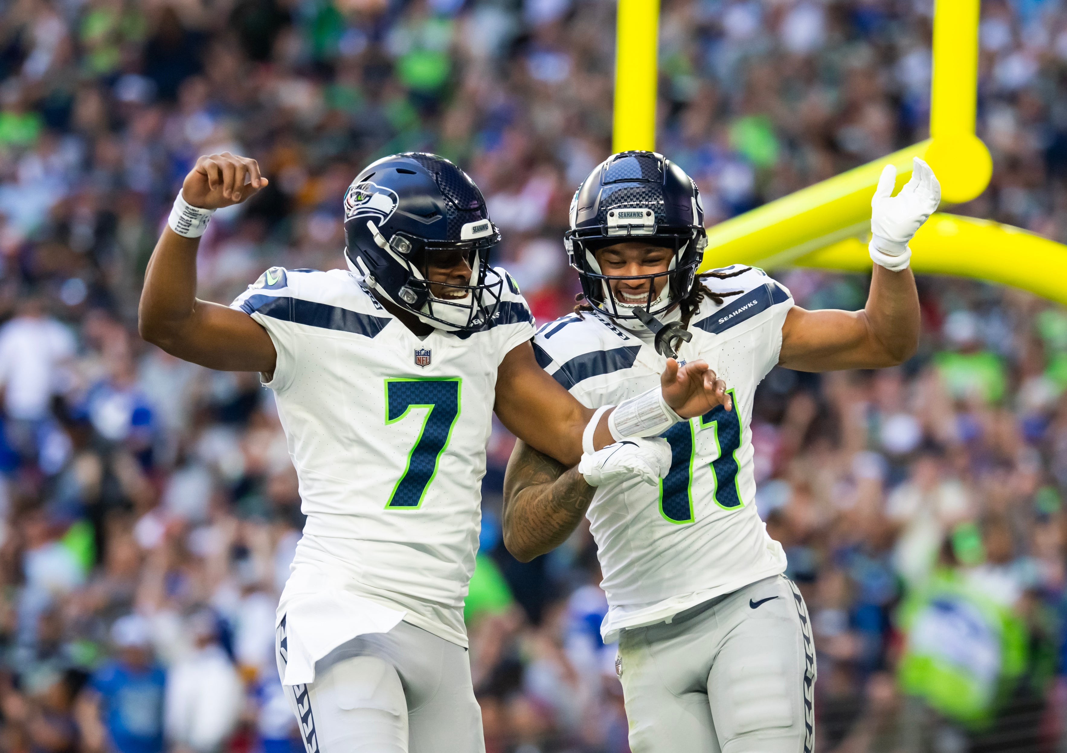 Dec 8, 2024; Glendale, Arizona, USA; Seattle Seahawks quarterback Geno Smith (7) celebrates a touchdown with wide receiver Jaxon Smith-Njigba (11) against the Arizona Cardinals in the first half at State Farm Stadium.