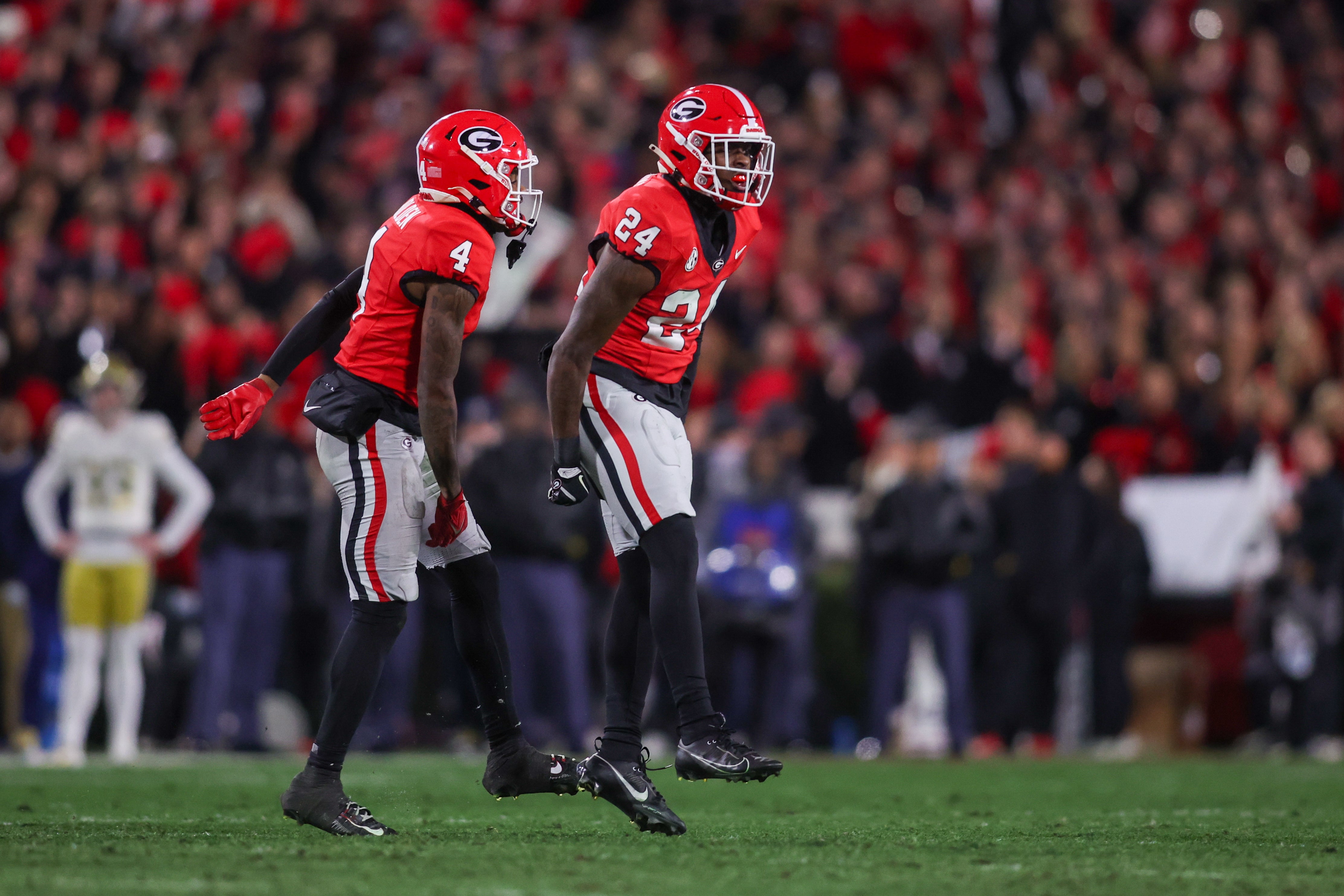 Georgia Bulldogs defensive back KJ Bolden (4) and defensive back Malaki Starks (24) react after a turnover on downs against the Georgia Tech Yellow Jackets in the first quarter at Sanford Stadium.