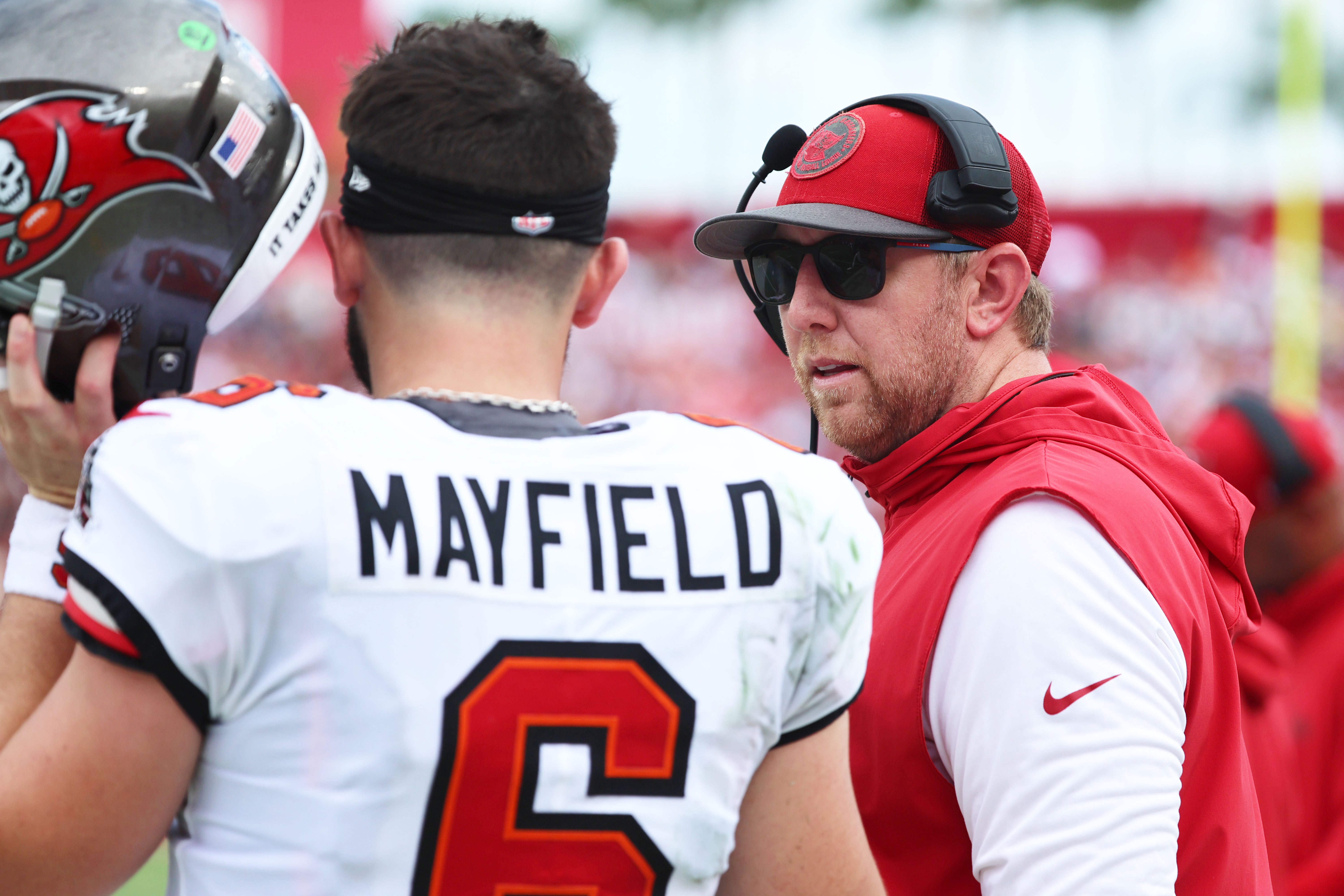 Sep 8, 2024; Tampa, Florida, USA; Tampa Bay Buccaneers quarterback Baker Mayfield (6) talks with offensive coordinator Liam Coen against the Washington Commanders during the first half at Raymond James Stadium.