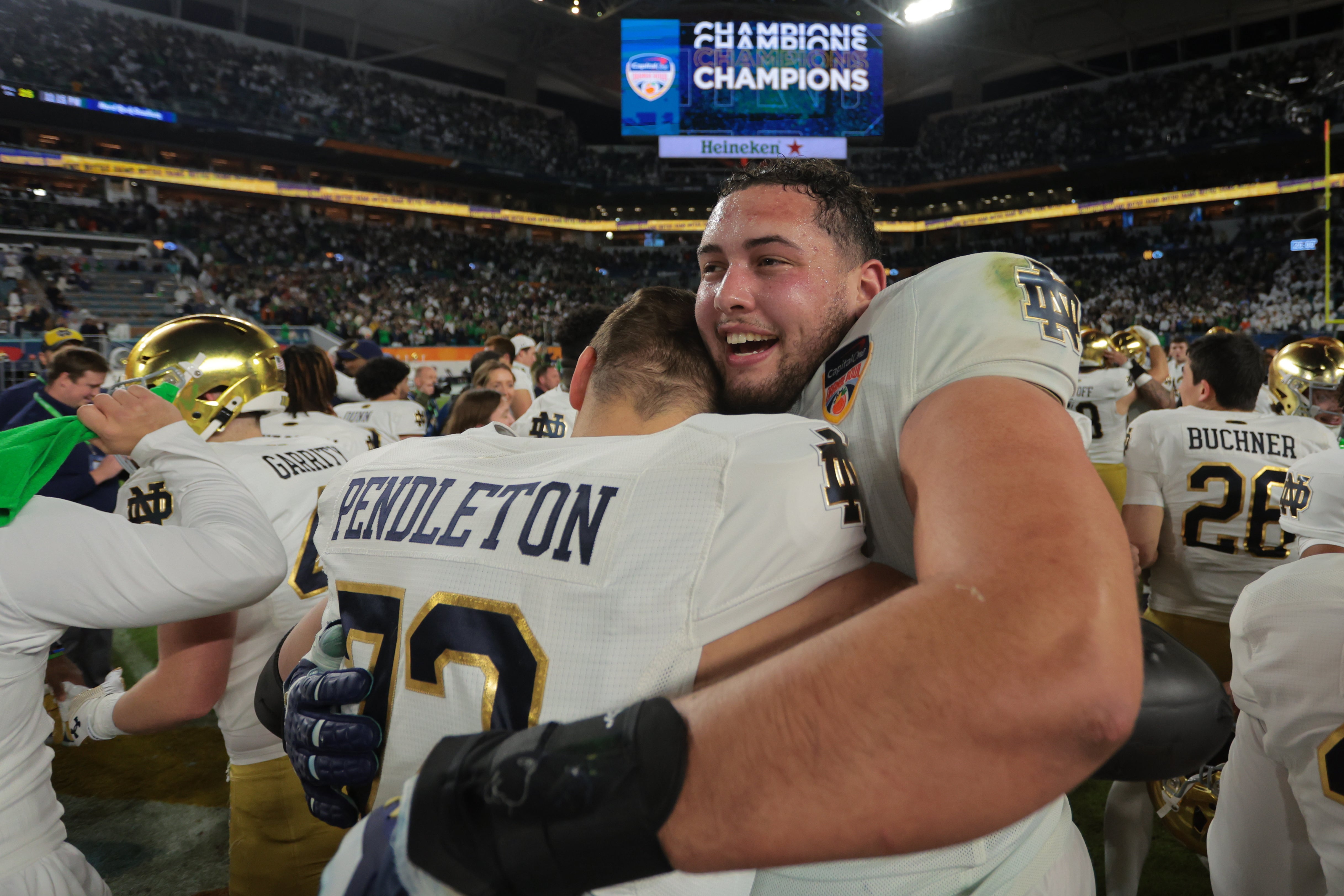Notre Dame Fighting Irish offensive lineman Tosh Baker (79) celebrates with offensive lineman Sam Pendleton (72) after defeating the Penn State Nittany Lions in the Orange Bowl at Hard Rock Stadium.