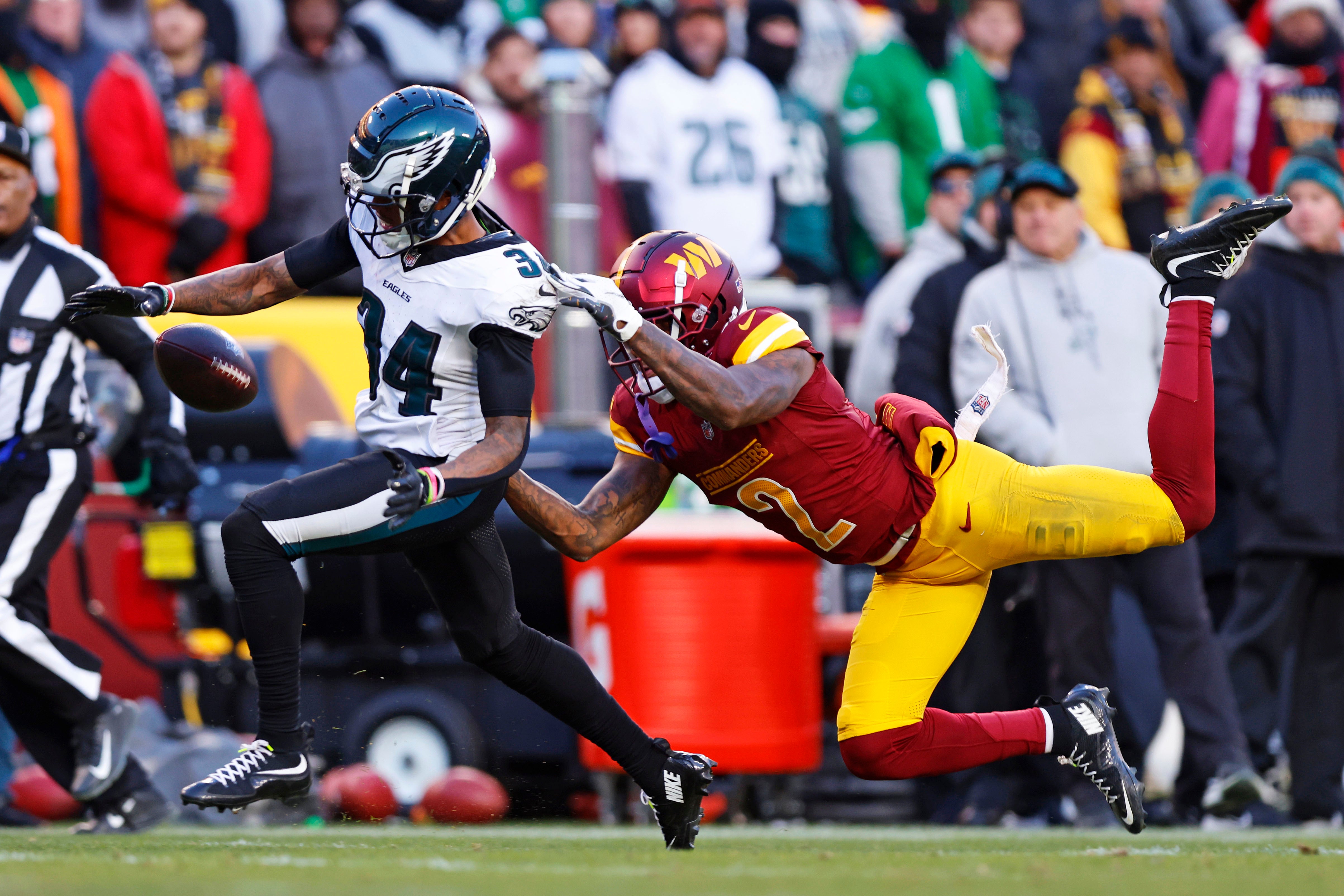 Philadelphia Eagles cornerback Isaiah Rodgers (34) breaks up a pass intended Washington Commanders wide receiver Dyami Brown (2) during the fourth quarter at Northwest Stadium.
