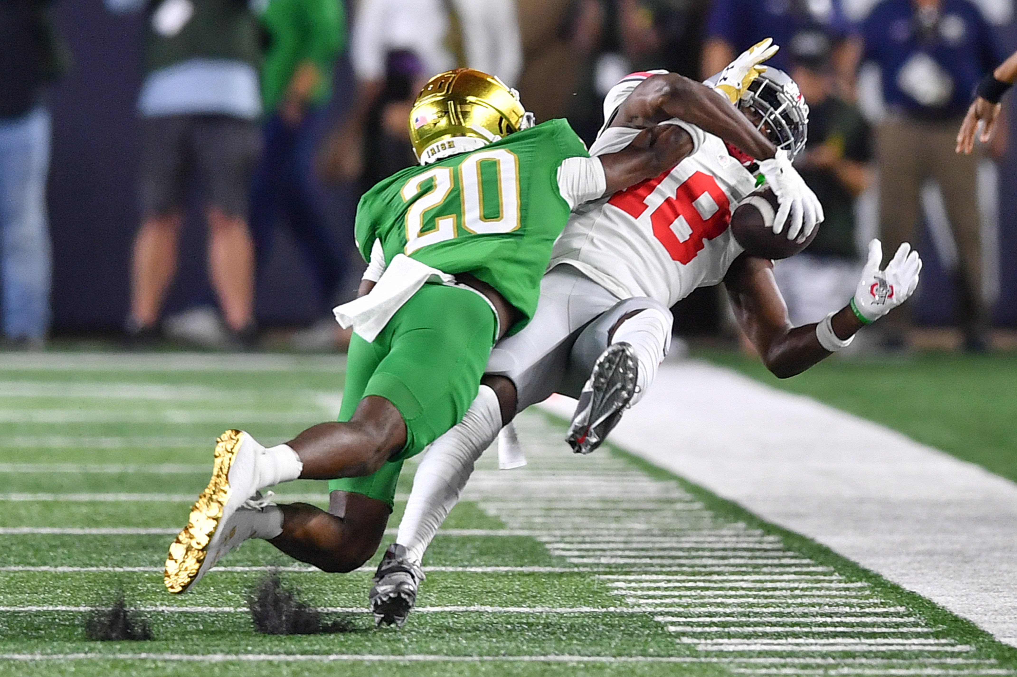 Sep 23, 2023; South Bend, Indiana, USA; Ohio State Buckeyes wide receiver Marvin Harrison Jr. (18) makes a catch as Notre Dame Fighting Irish cornerback Benjamin Morrison (20) defends in the second quarter at Notre Dame Stadium. The catch was reviewed and ruled and incomplete pass and Morrison was given a pass interference penalty.