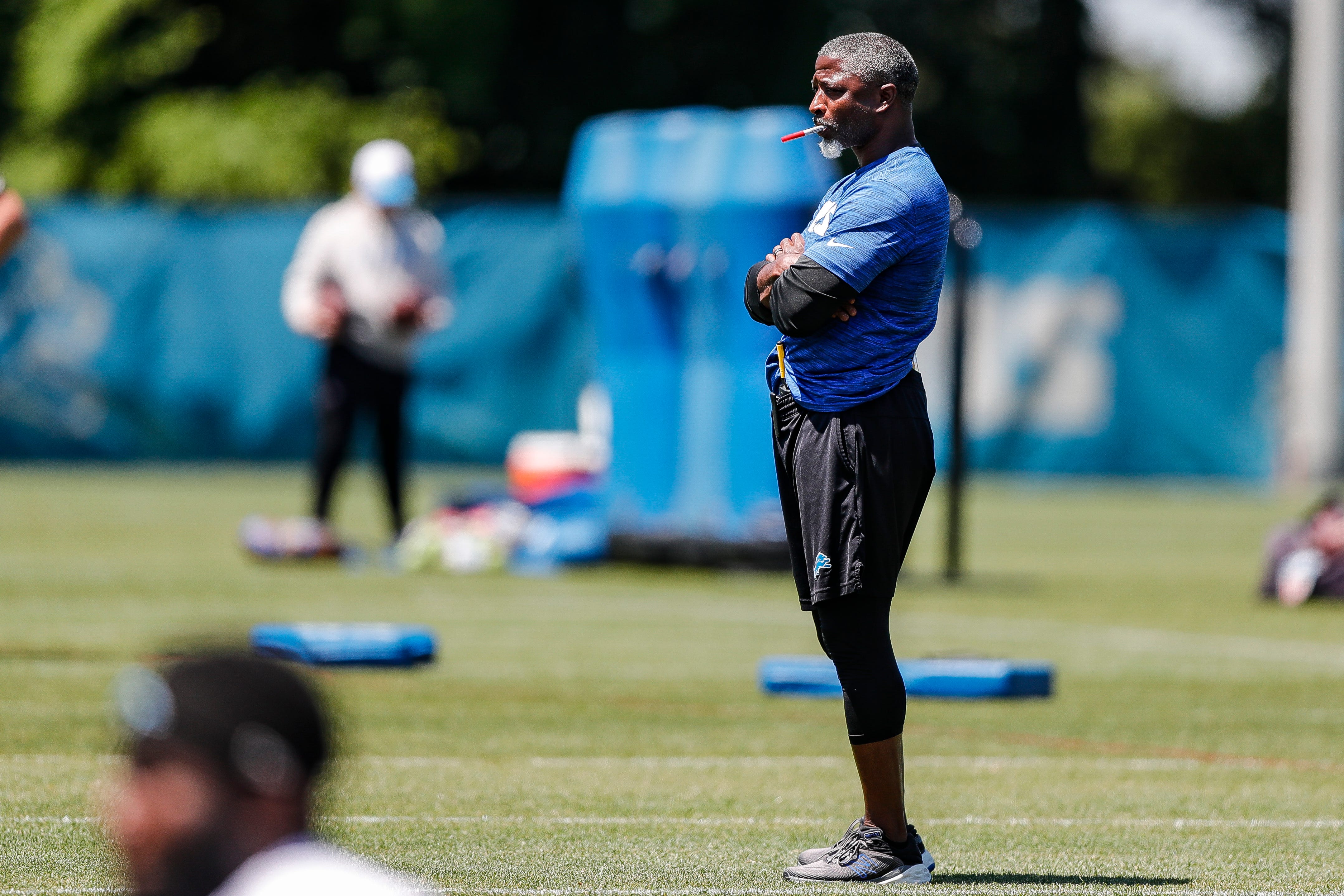 Detroit Lions defensive coordinator Aaron Glenn watches practice during OTAs at Detroit Lions headquarters and practice facility in Allen Park on Tuesday, June 11, 2024.