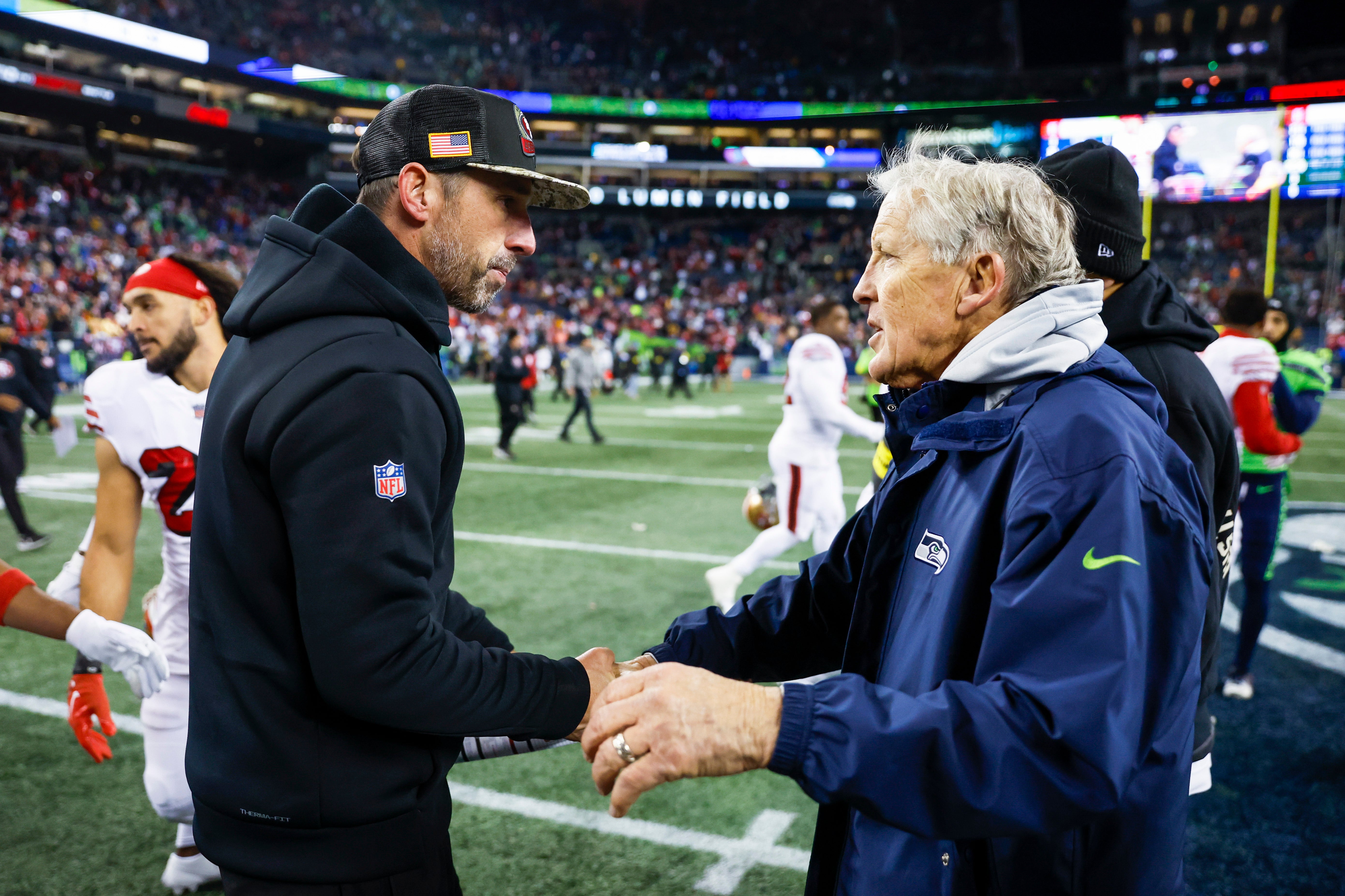 San Francisco 49ers head coach Kyle Shanahan, left, shakes hands with Seattle Seahawks head coach Pete Carroll following a 21-13 San Francisco victory at Lumen Field.