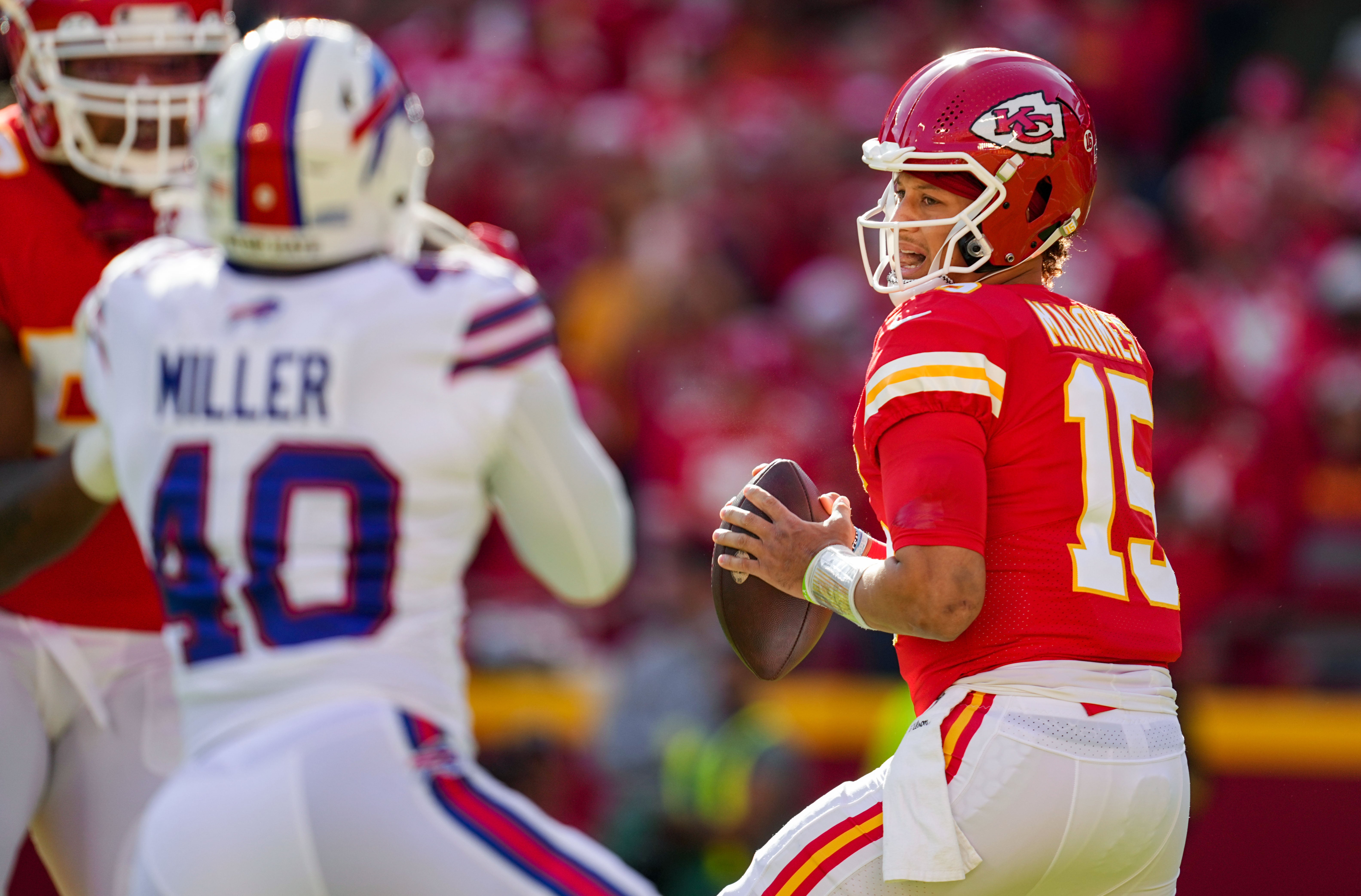Chiefs quarterback Patrick Mahomes (15) drops back to pass as Bills linebacker Von Miller (40) defends.