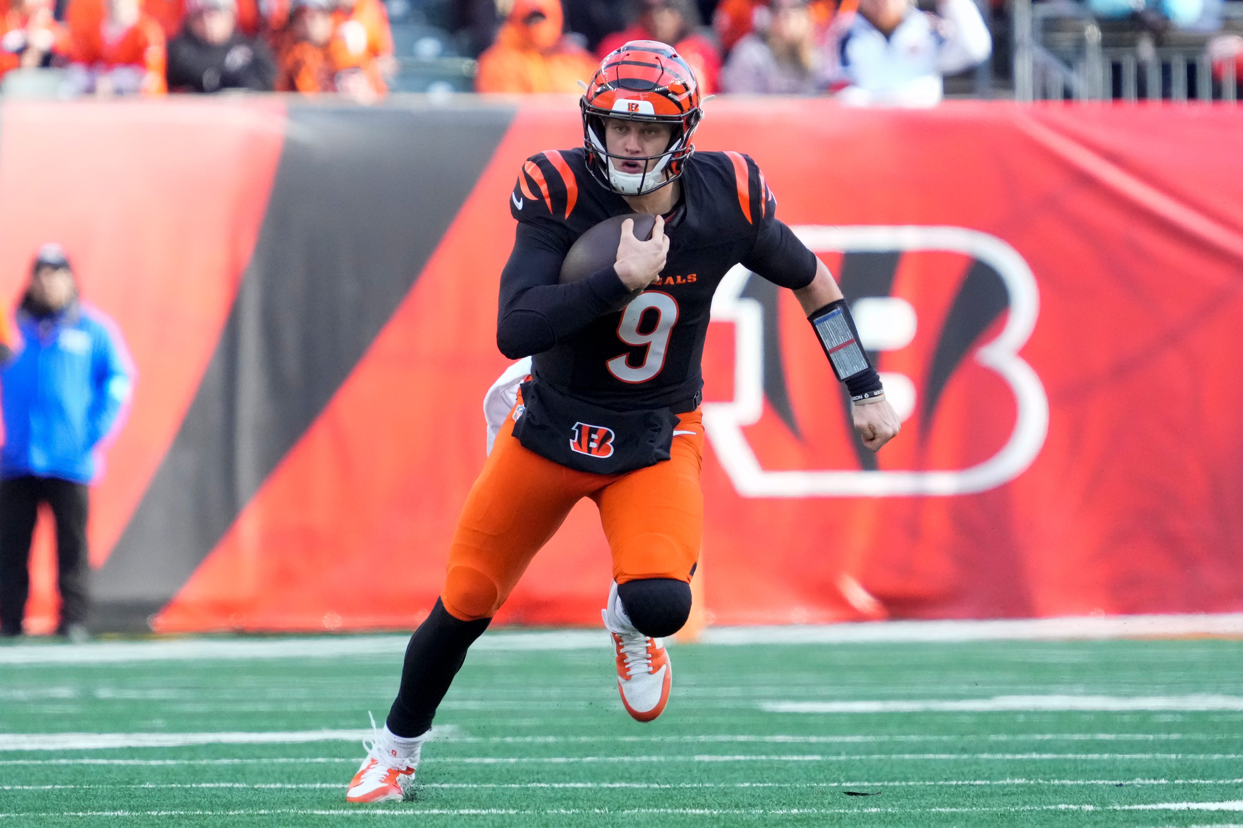 Cincinnati Bengals quarterback Joe Burrow (9) runs for a first down in the second quarter of the NFL Week 16 game between the Cincinnati Bengals and the Cleveland Browns at Paycor Stadium in downtown Cincinnati on Sunday, Dec. 22, 2024. The Bengals led 17-0 at halftime.