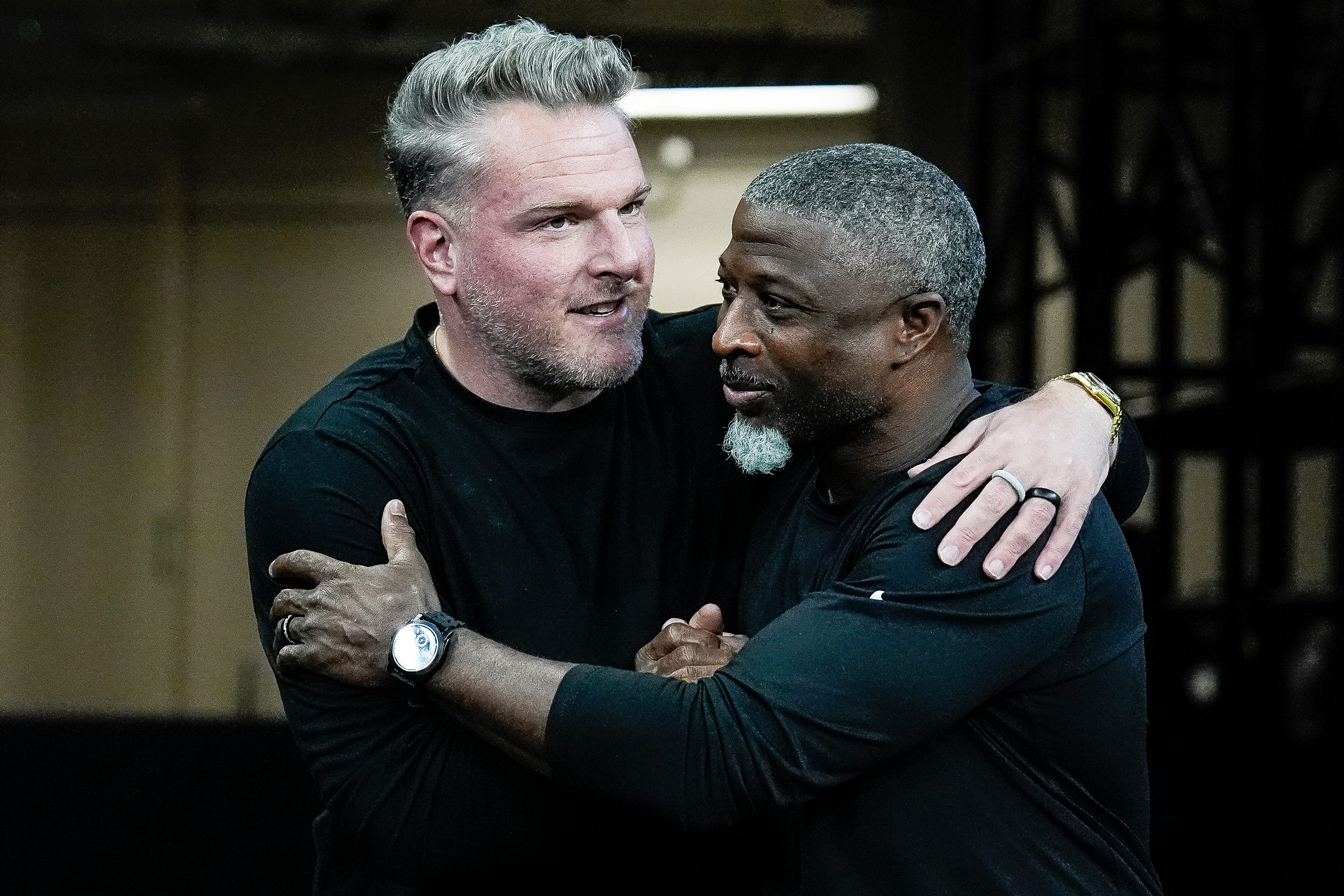 Pat McAfee hugs Detroit Lions defensive coordinator Aaron Glenn before the game between Indianapolis Colts and Detroit Lions at Lucas Oil Stadium on Sunday, Nov. 24, 2024.