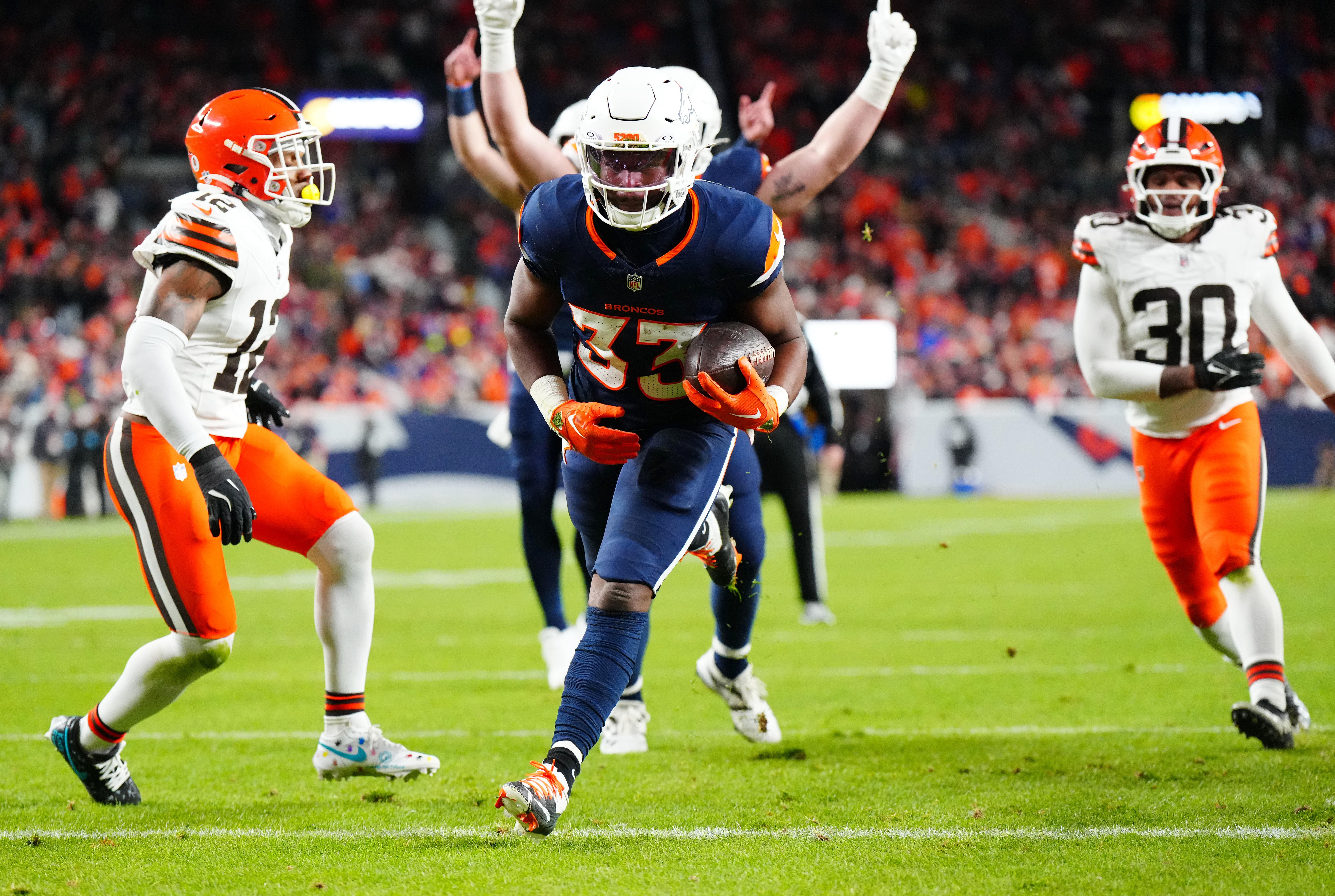 Dec 2, 2024; Denver, Colorado, USA; Denver Broncos running back Javonte Williams (33) scores a touchdown in the first quarter against the Cleveland Browns at Empower Field at Mile High.