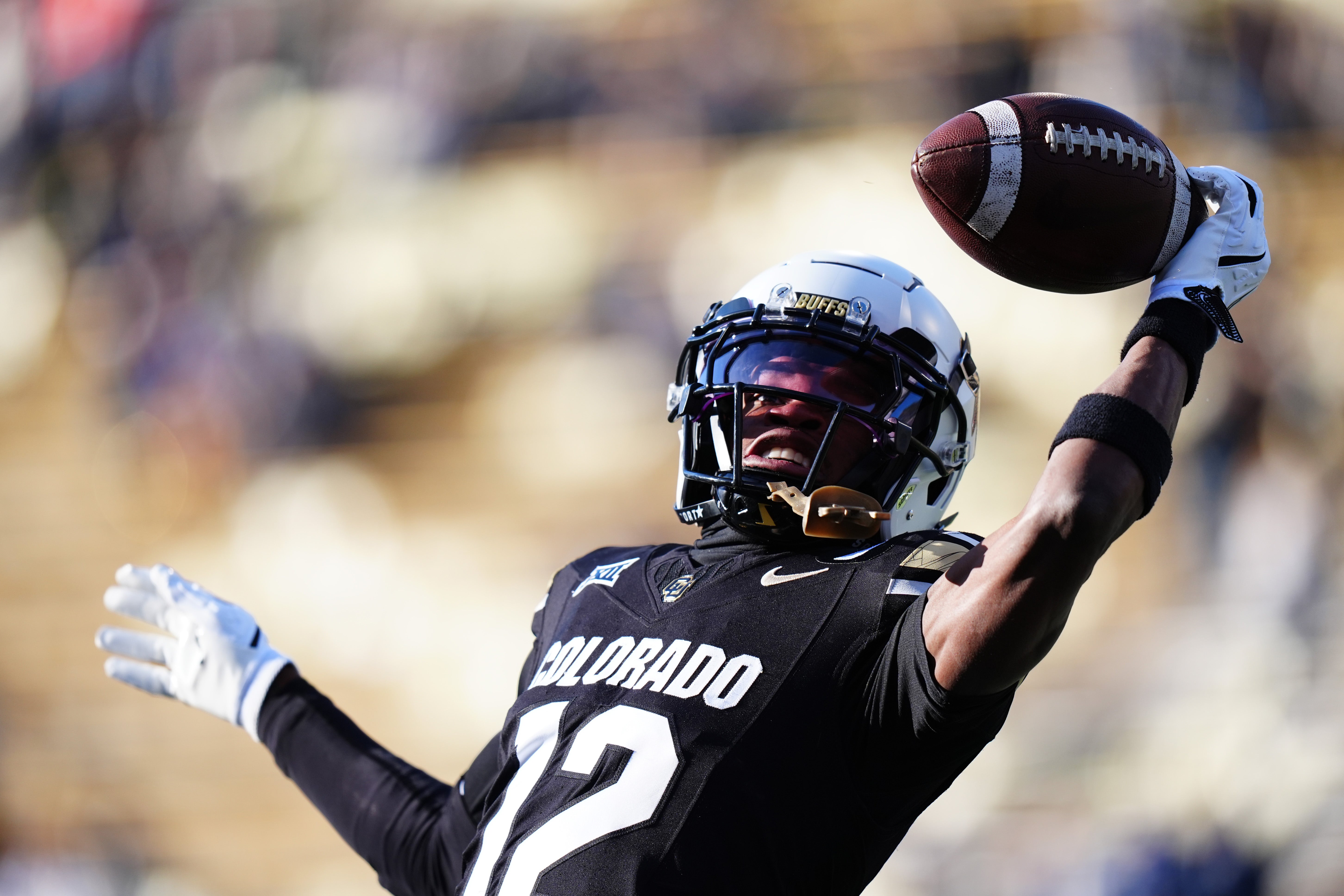 Colorado Buffaloes wide receiver Travis Hunter (12) warms up before the game against the Oklahoma State Cowboys at Folsom Field.