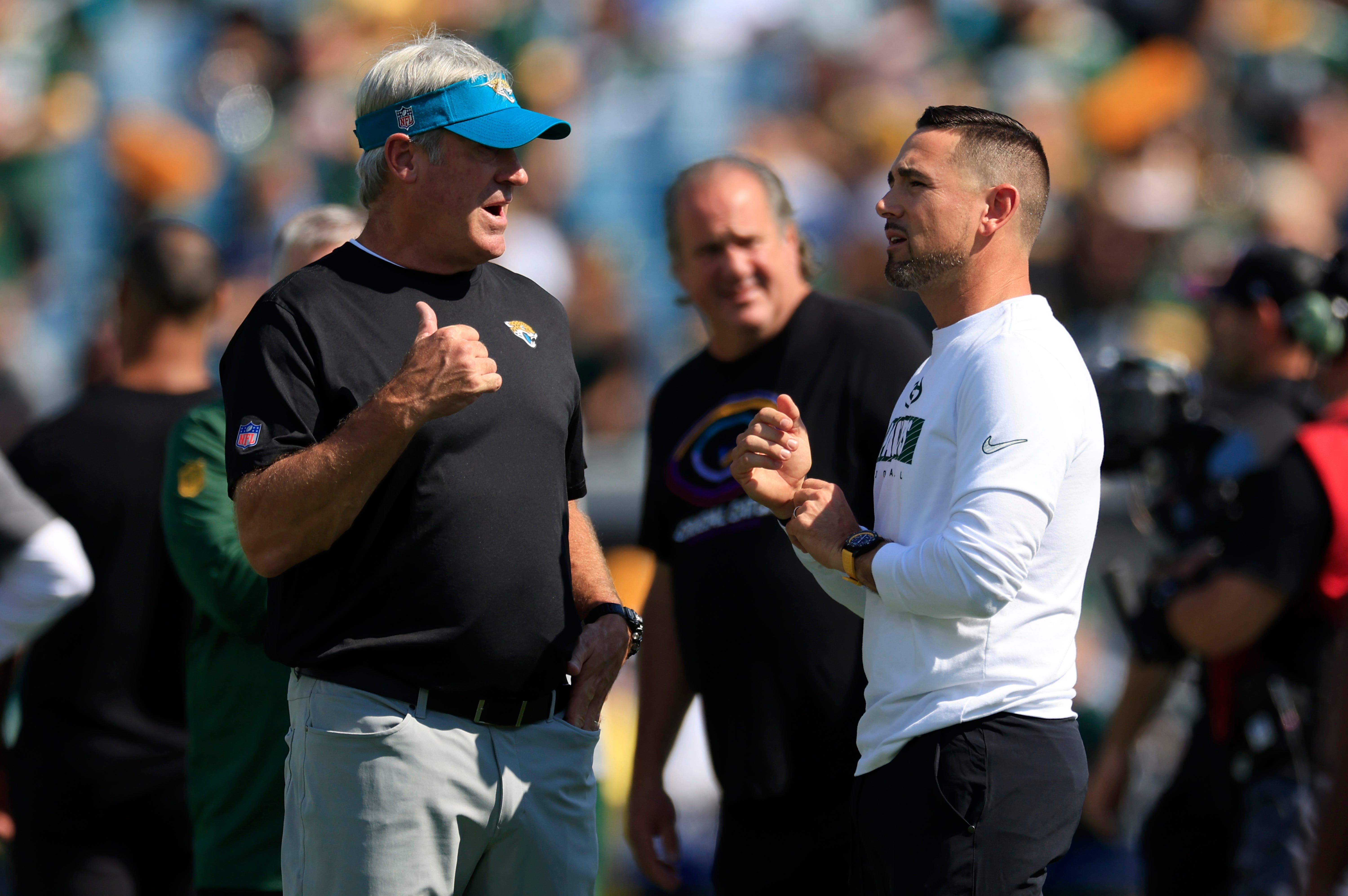 Jacksonville Jaguars head coach Doug Pederson, left, and Green Bay Packers head coach Matt LaFleur talk before an NFL football matchup Sunday, Oct. 27, 2024 at EverBank Stadium in Jacksonville, Fla.