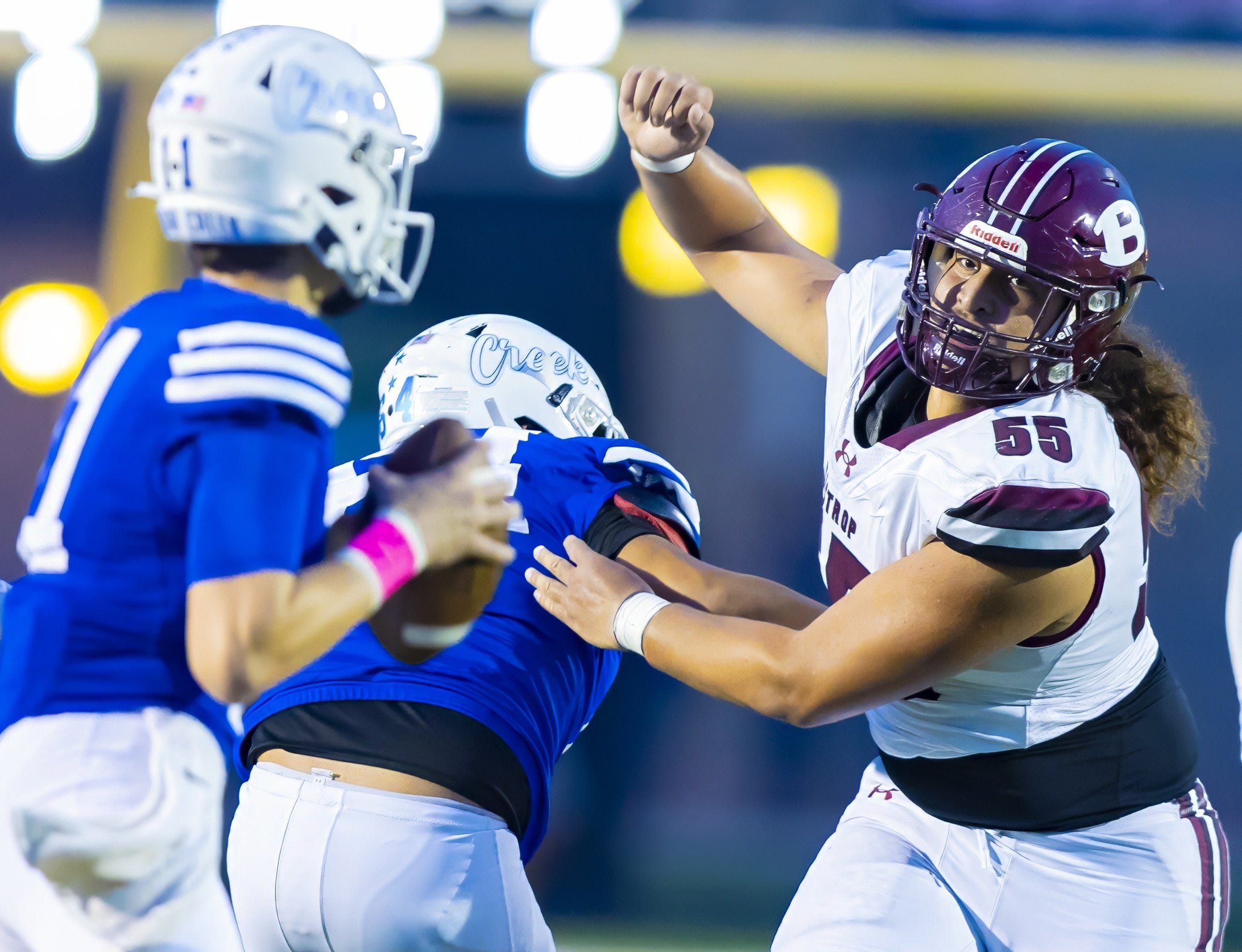 Bastrop Bears defensive lineman Tiki Hola (55) rushes toward Cedar Creek Eagles quarterback Blaze Orr (11 in the first quarter )at the District 13-5A football game on Friday, October 6, 2023, at Bastrop Memorial Stadium - Bastrop, Texas.