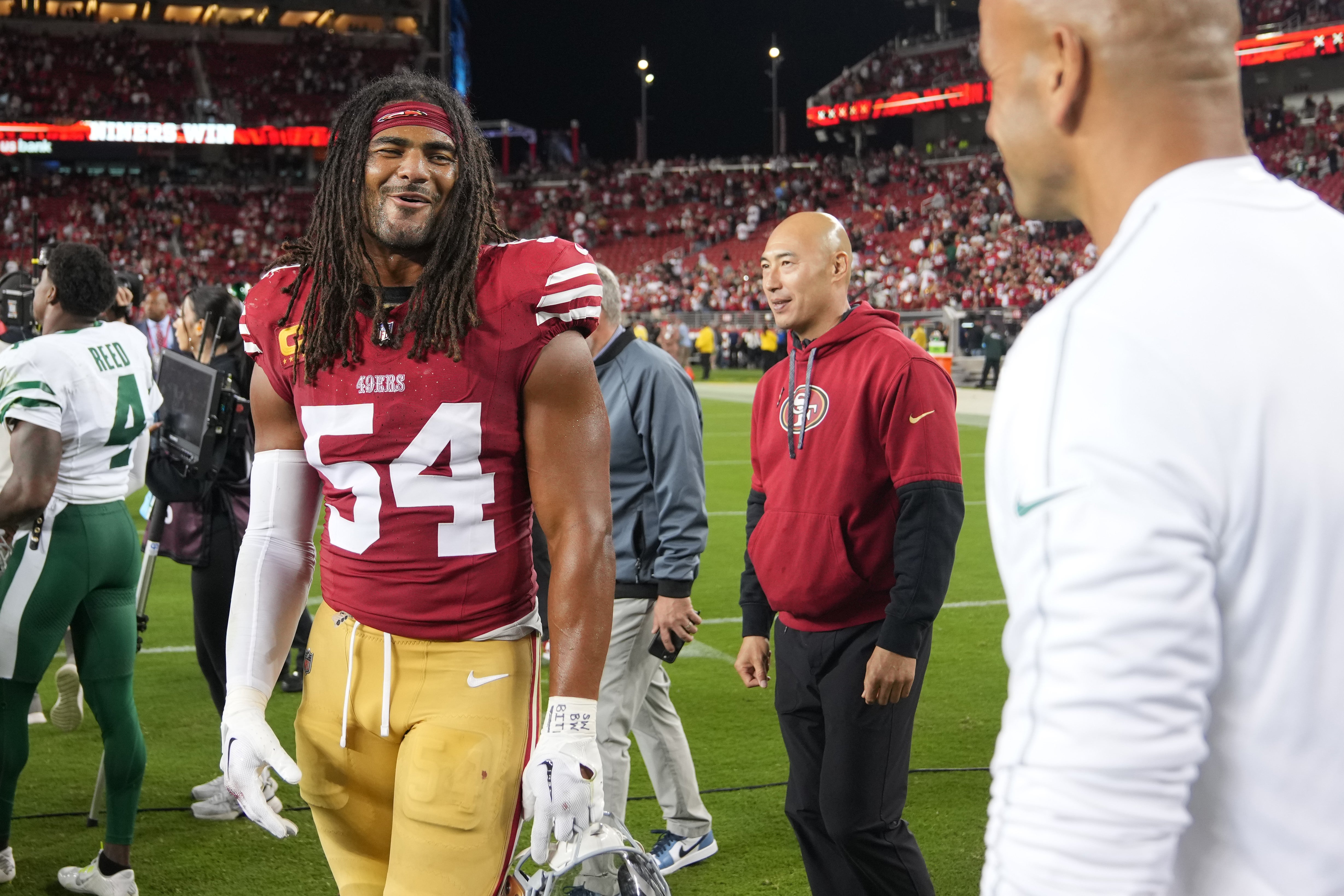San Francisco 49ers linebacker Fred Warner (54) talks with New York Jets head coach Robert Saleh (right) after the game at Levi's Stadium.