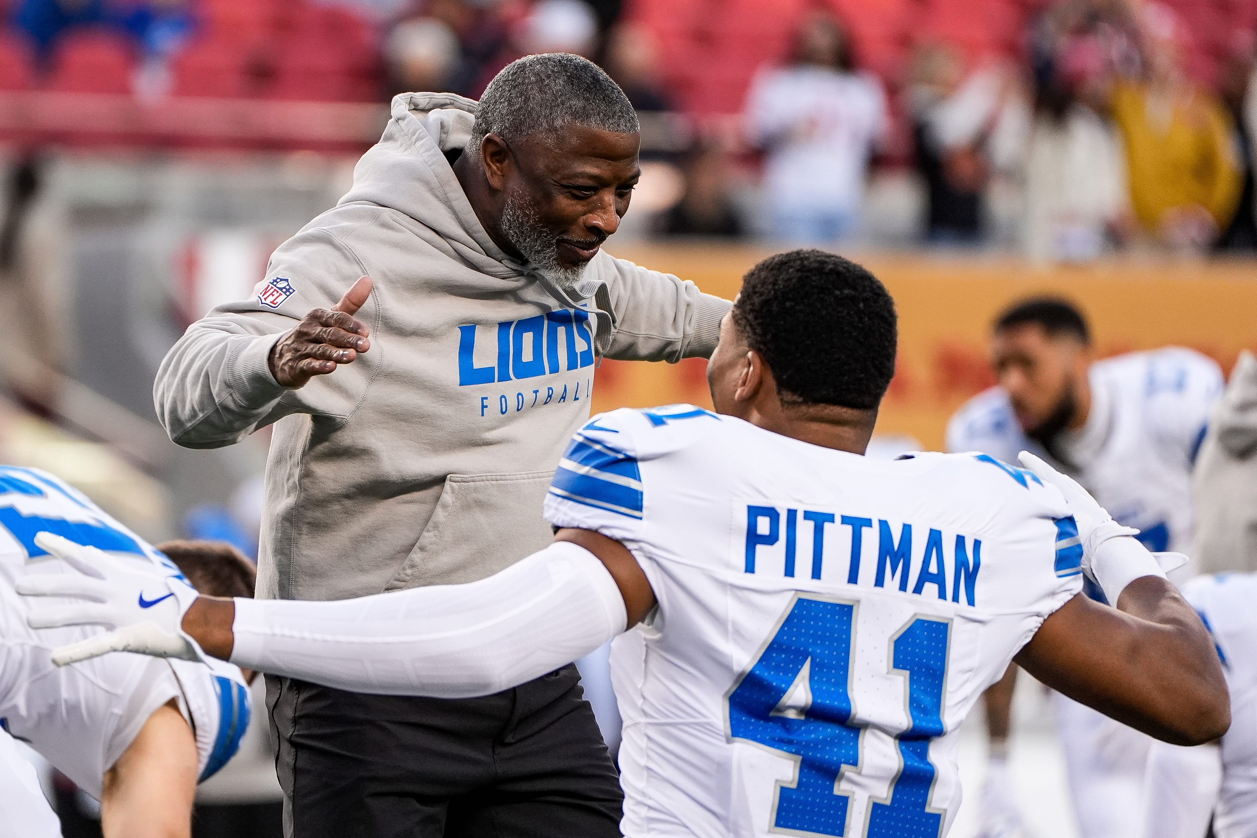 Detroit Lions defensive coordinator Aaron Glenn hugs linebacker Anthony Pittman during warmups before the game against the San Francisco 49ers at Levi's Stadium in Santa Clara, Calif. on Monday, Dec. 30, 2024.