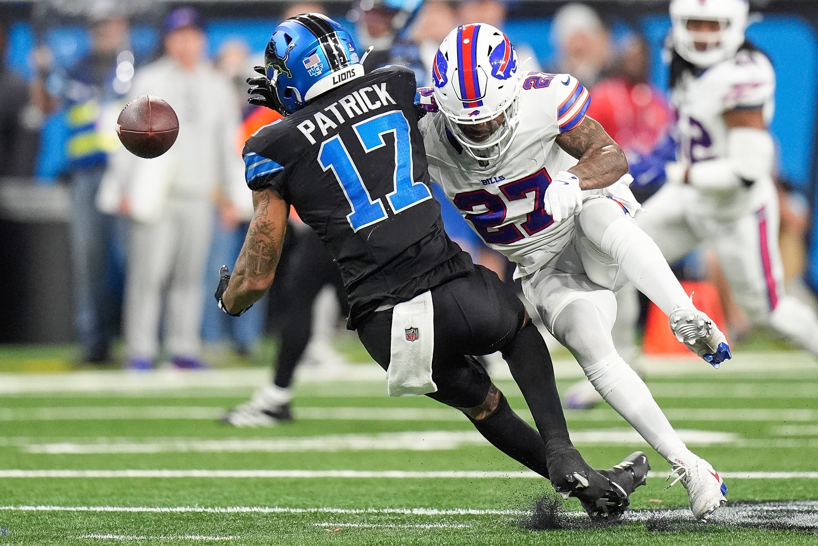 Buffalo Bills safety Kareem Jackson (27) breaks a pass against Detroit Lions wide receiver Tim Patrick (17) during the second half at Ford Field in Detroit on Sunday, Dec. 15, 2024.