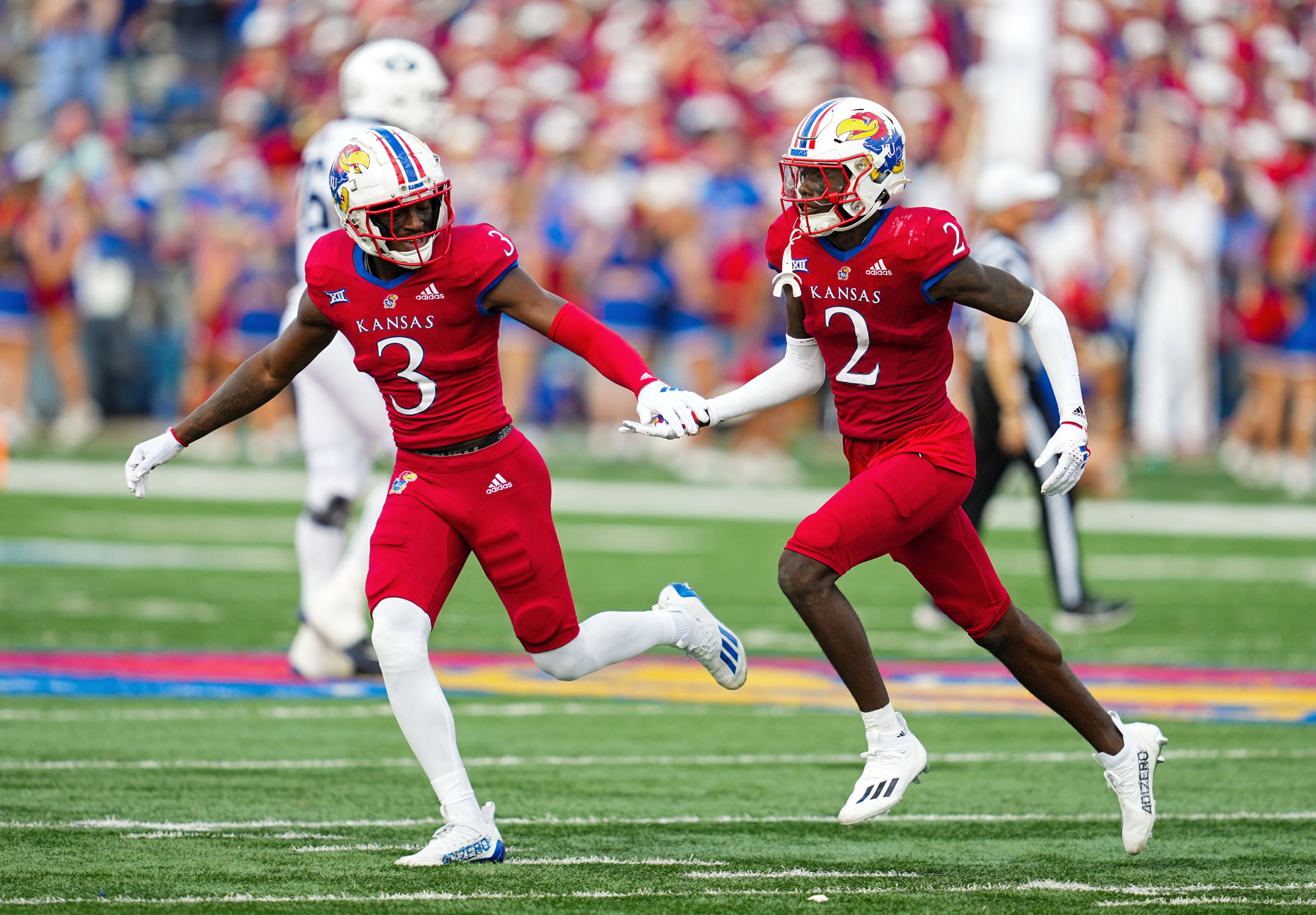 Sep 23, 2023; Lawrence, Kansas, USA; Kansas Jayhawks cornerback Cobee Bryant (2) celebrates with cornerback Mello Dotson (3) after an interception against the Brigham Young Cougars during the second half at David Booth Kansas Memorial Stadium.