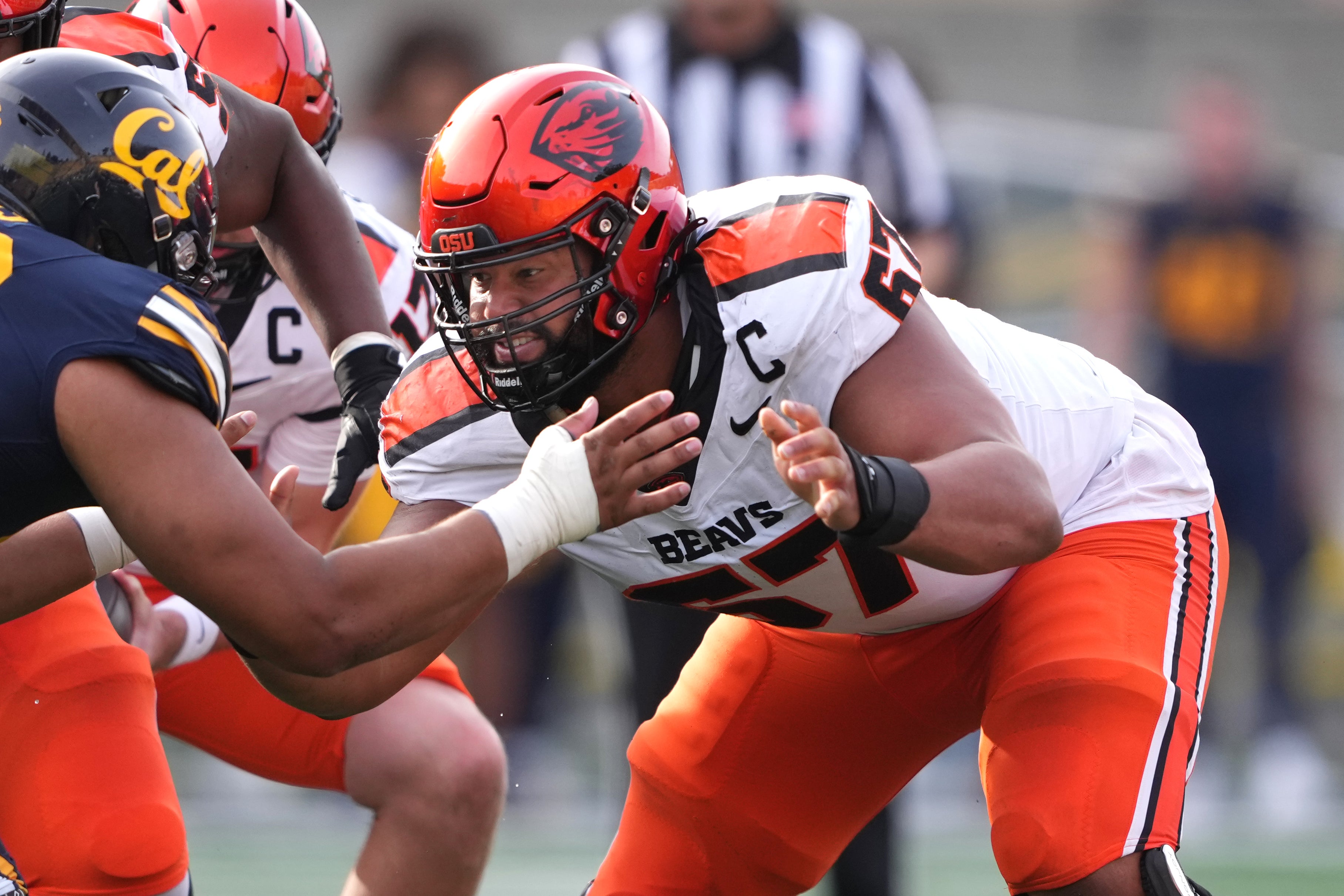 Oct 26, 2024; Berkeley, California, USA; Oregon State Beavers offensive lineman Joshua Gray (center) blocks California Golden Bears defensive lineman Derek Wilkins (left) during the fourth quarter at California Memorial Stadium.