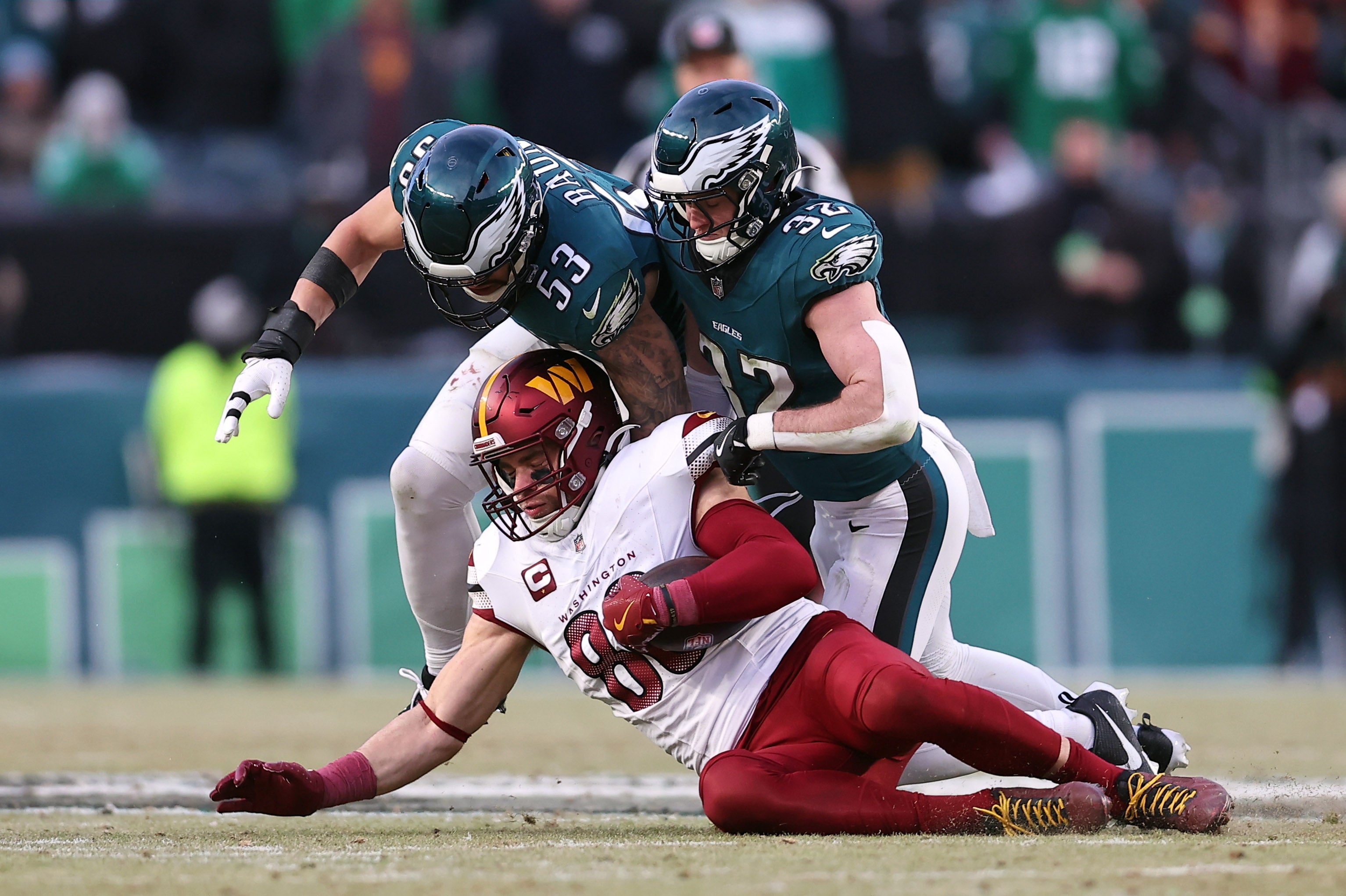 Jan 26, 2025; Philadelphia, PA, USA; Philadelphia Eagles linebacker Zack Baun (53) and safety Reed Blankenship (32) tackle Washington Commanders tight end Zach Ertz (86) during the first half in the NFC Championship game at Lincoln Financial Field.