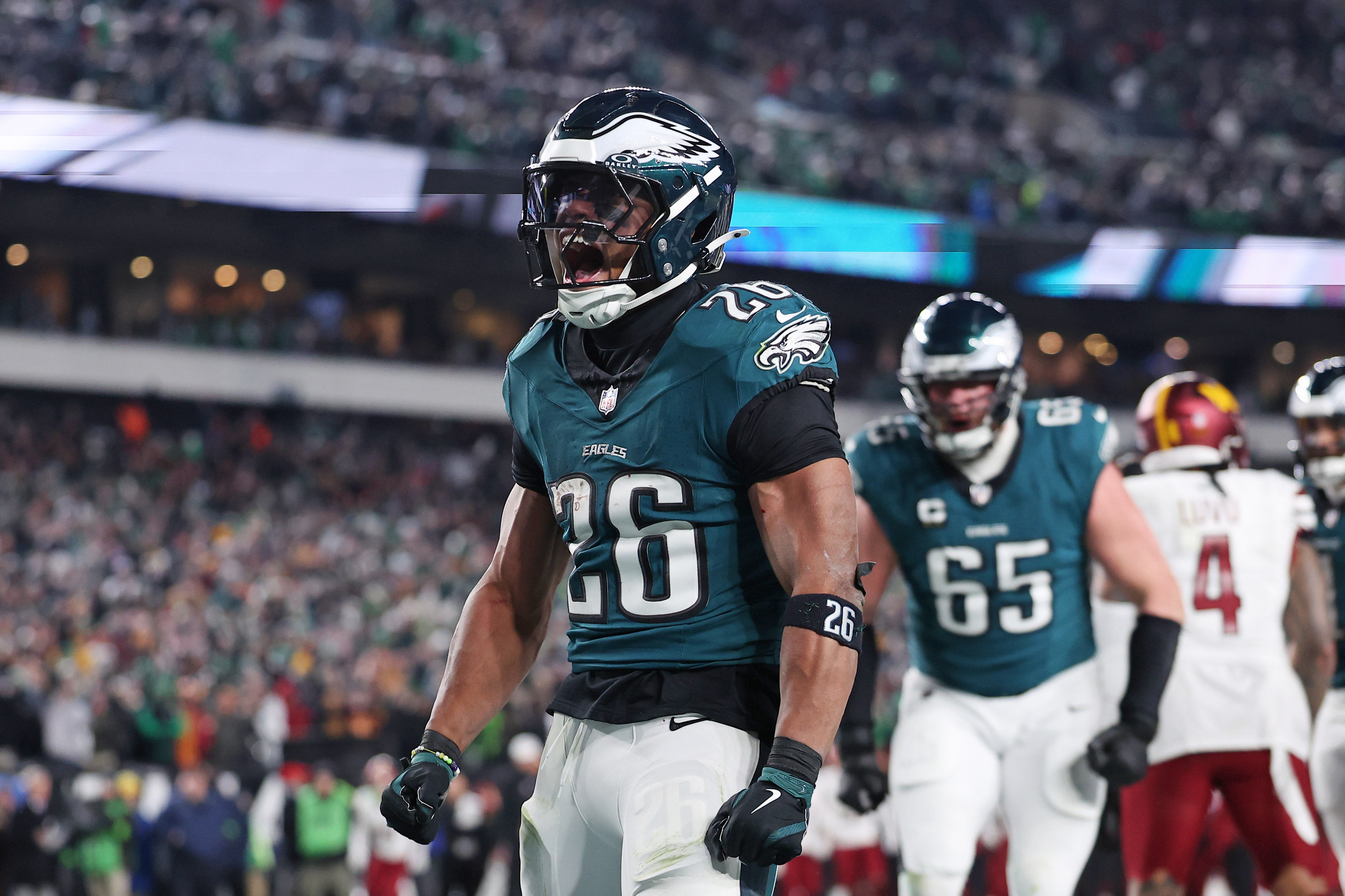 Philadelphia Eagles running back Saquon Barkley (26) celebrates after a touchdown against the Washington Commanders during the second half in the NFC Championship game at Lincoln Financial Field.