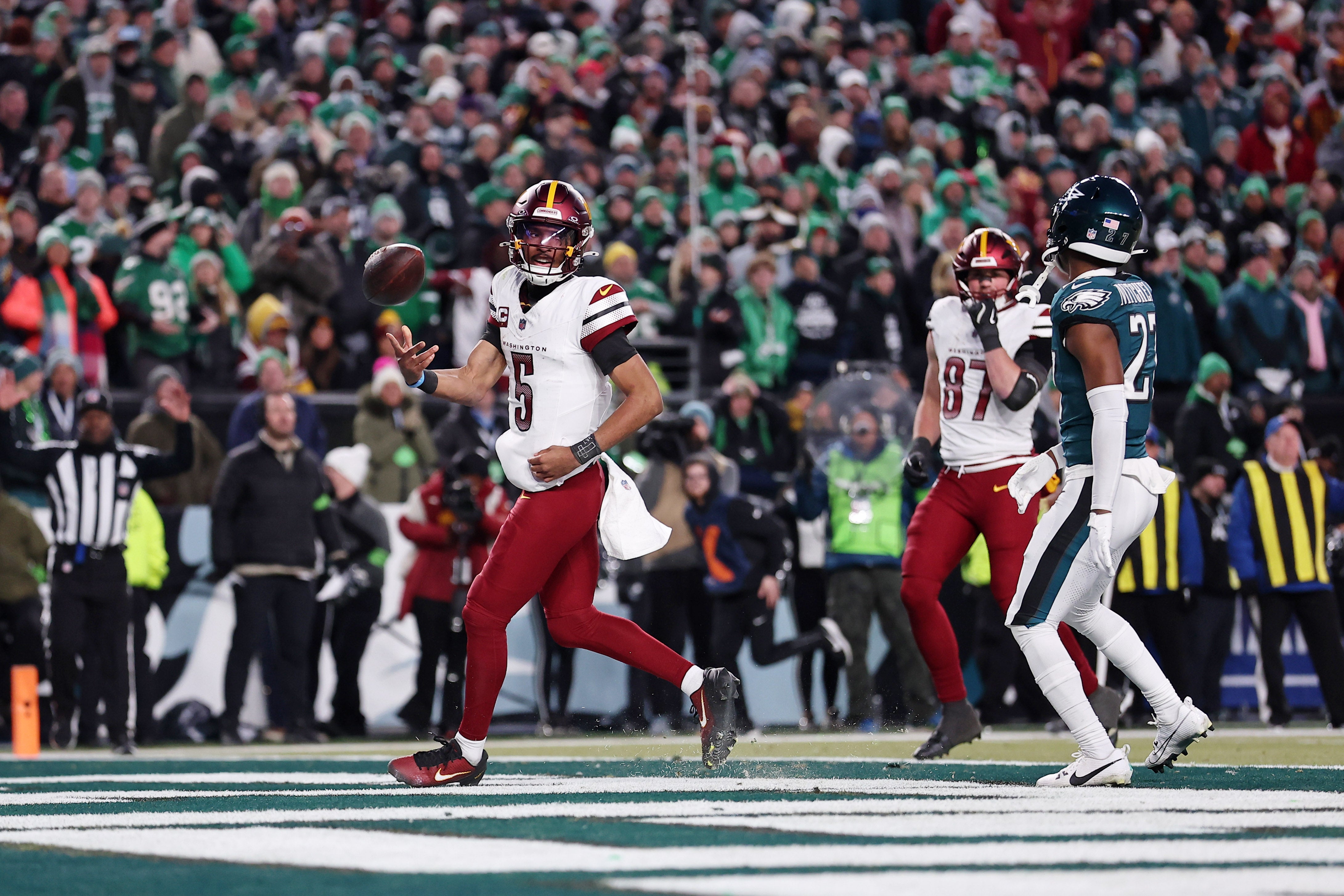 Jan 26, 2025; Philadelphia, PA, USA; Washington Commanders quarterback Jayden Daniels (5) scores a touchdown against the Philadelphia Eagles during the second half in the NFC Championship game at Lincoln Financial Field.