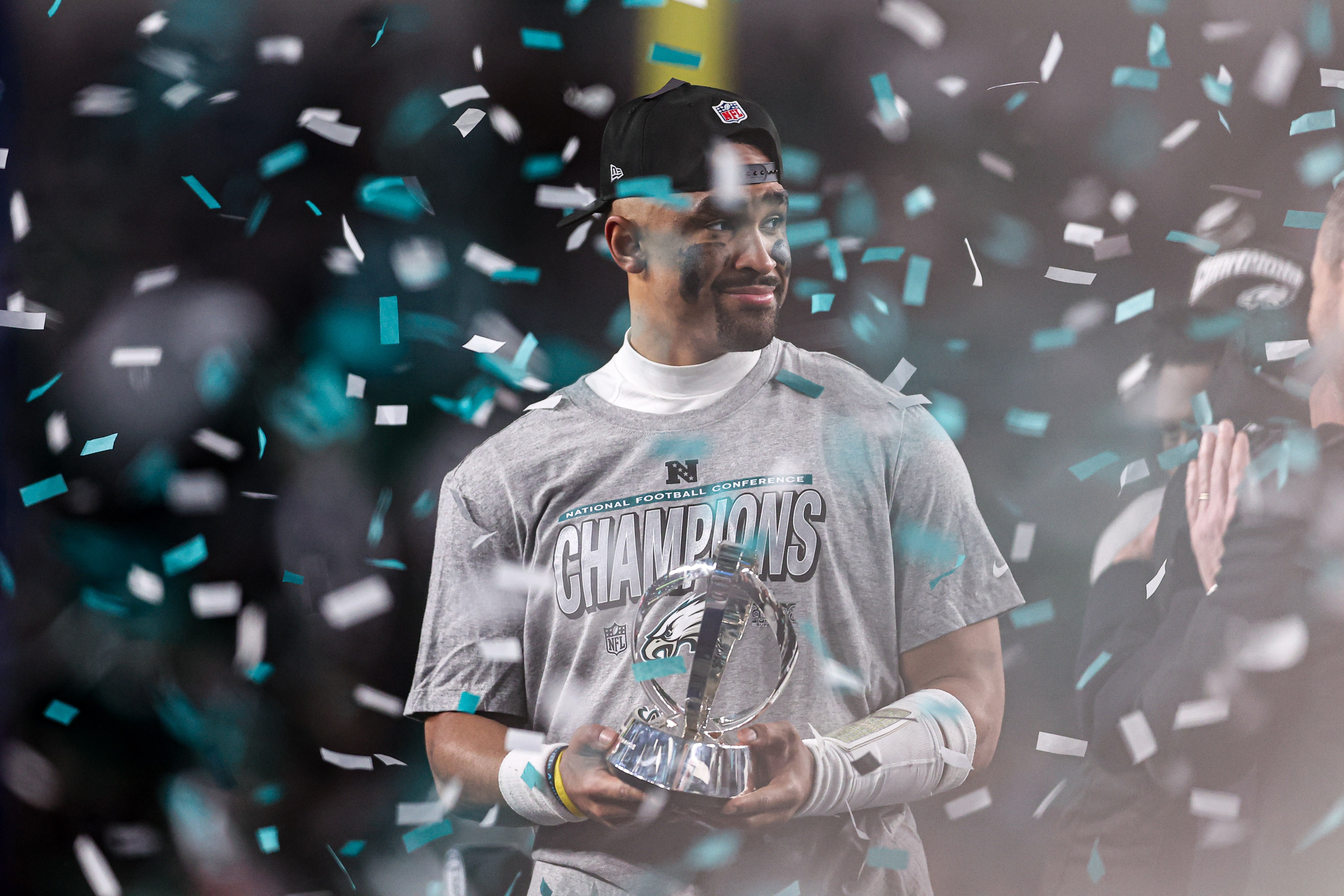 Philadelphia Eagles quarterback Jalen Hurts (1) holds the NFC Championship trophy after a victory in the NFC Championship game against the Washington Commanders at Lincoln Financial Field.